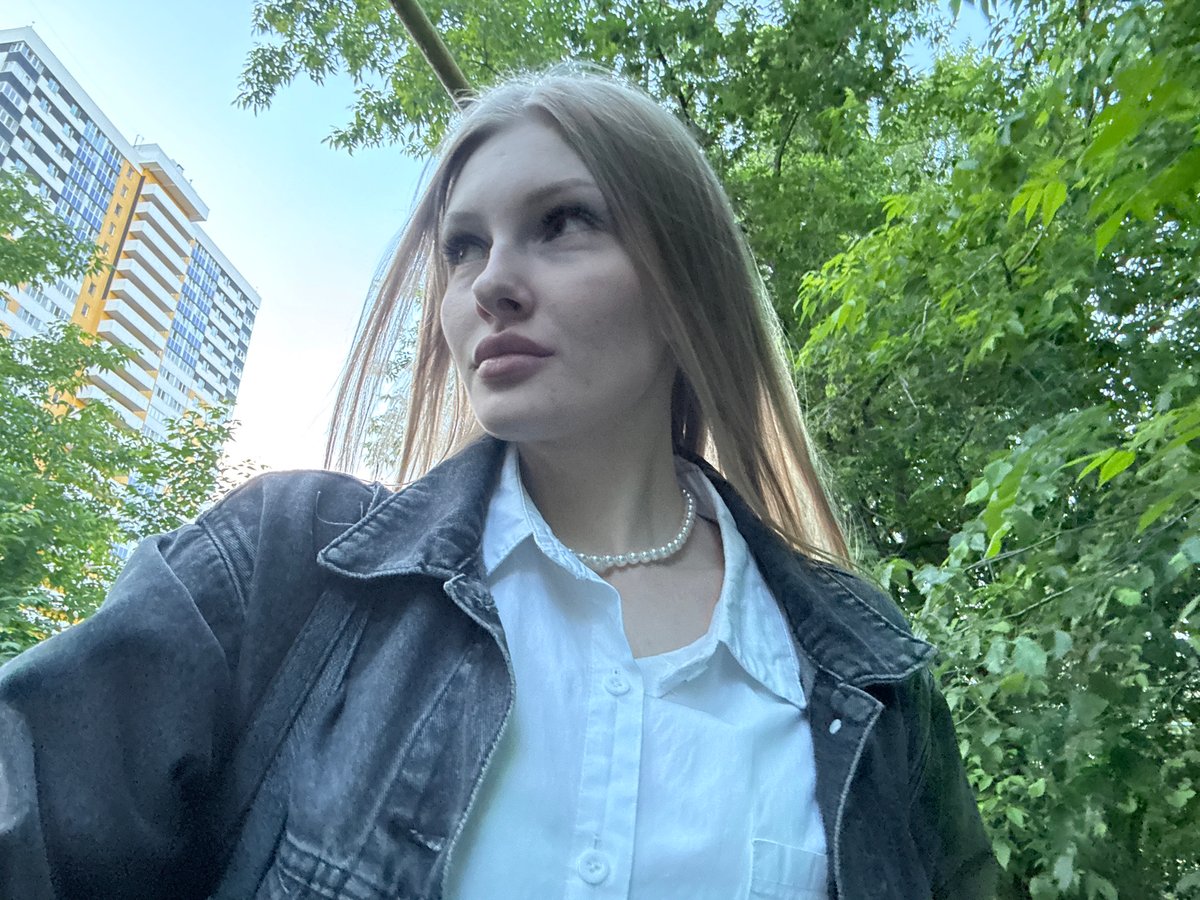 Young woman takes selfies during photo session in Perm