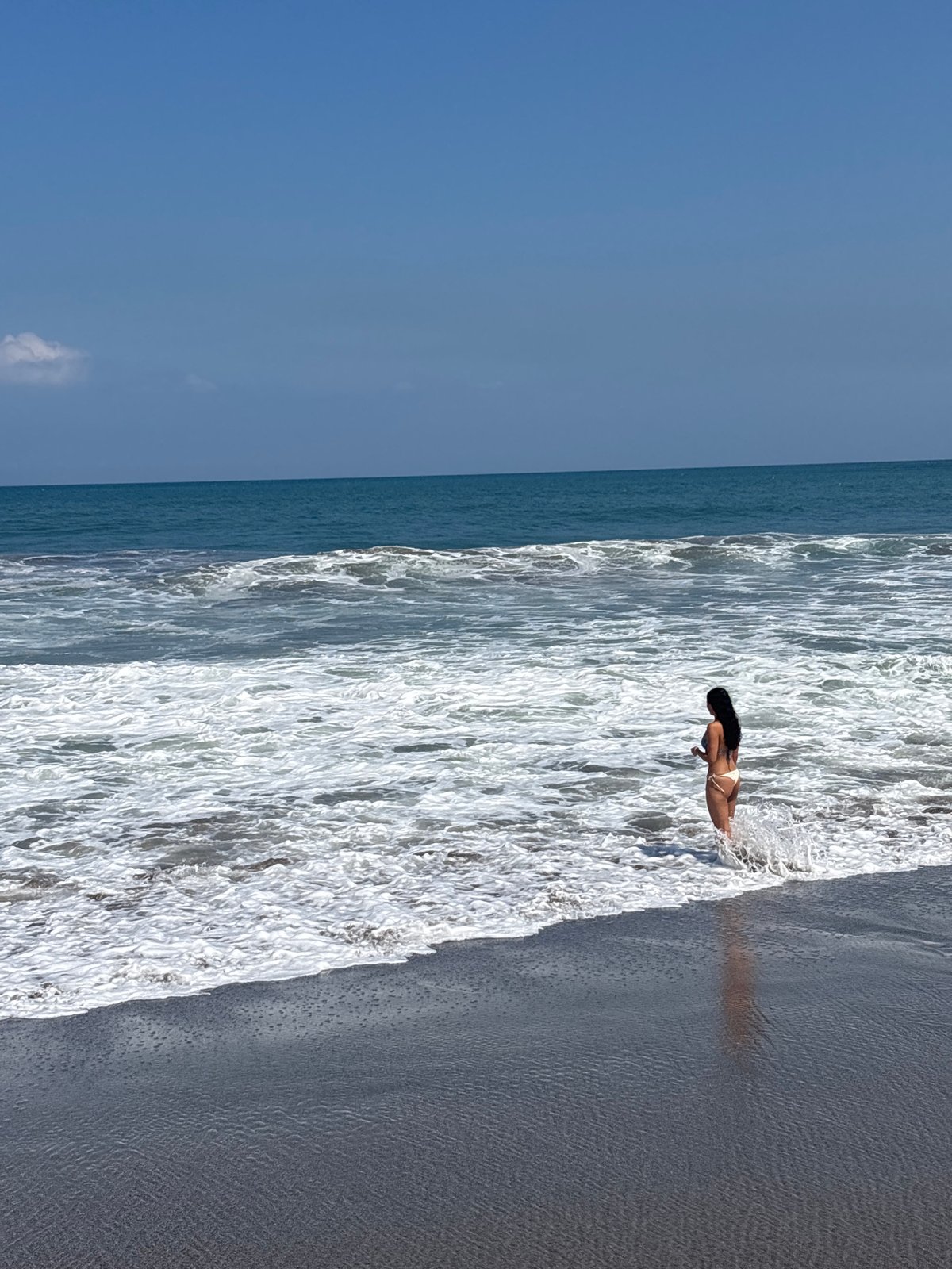 Sunny afternoon on North Kuta's dark sand beach