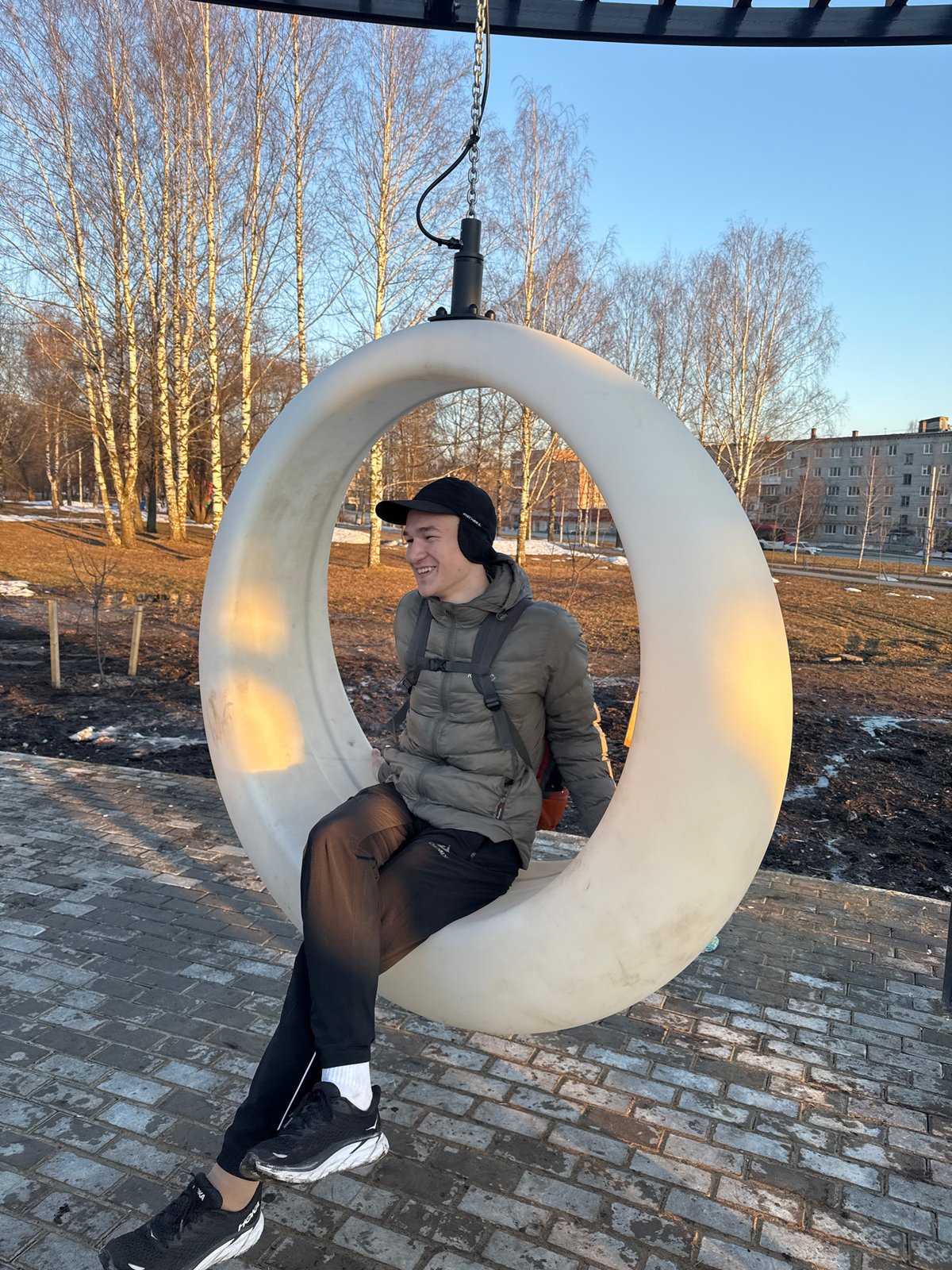 Young adults enjoy circular swings at Berezniki park playground