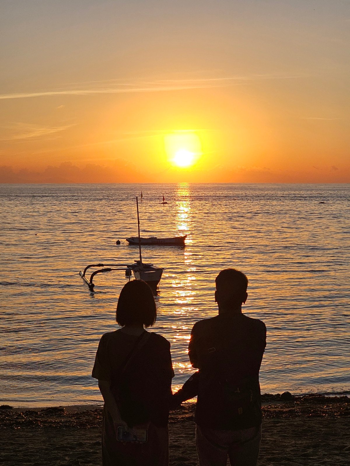 Sunset photography and traditional boats captured at Denpasar beach