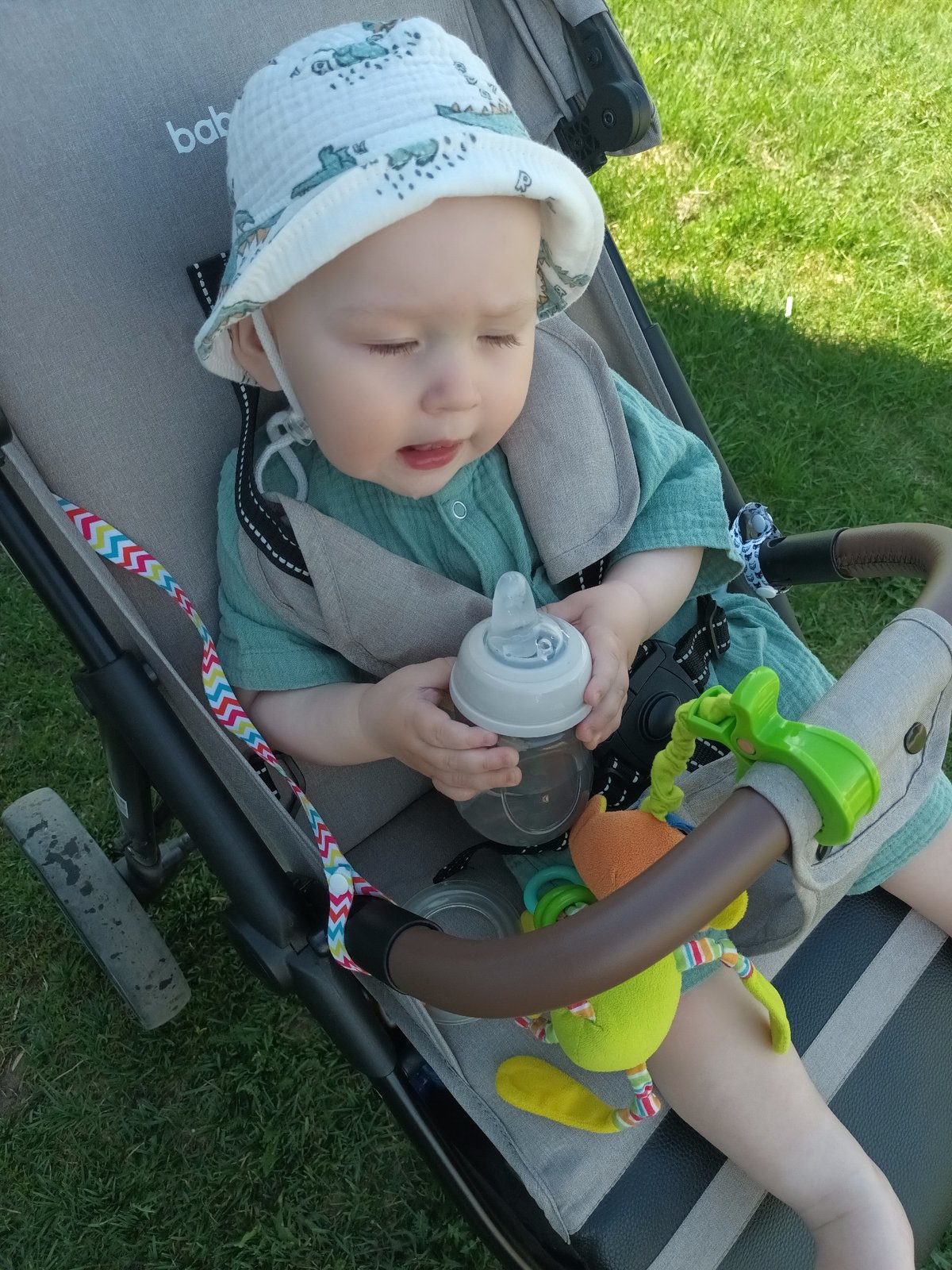Baby observed in stroller on lawn in Ольховка, Russia