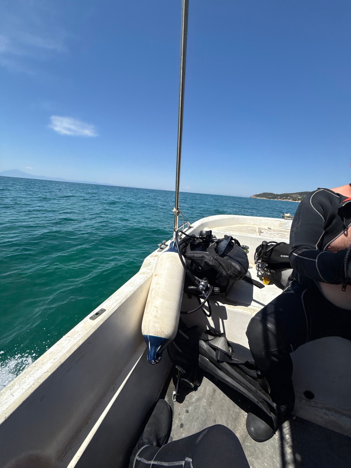 Scuba divers heading out on calm Aegean waters near Limenaria