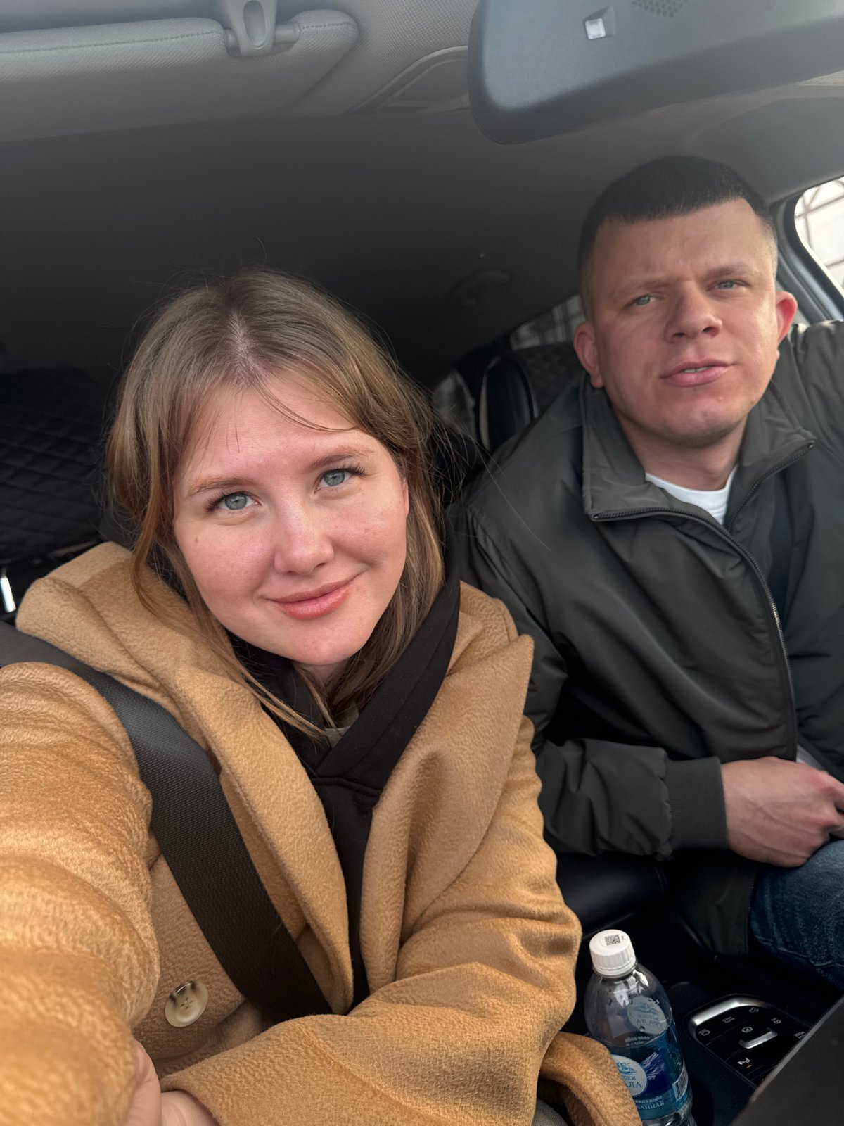 Two people take daytime car selfie in Russia