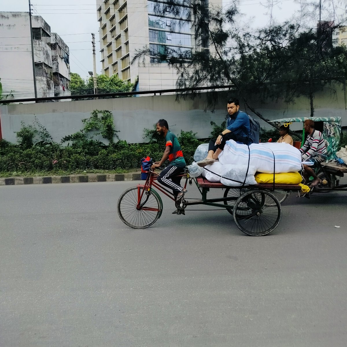 AC repair and street work on a Dhaka morning