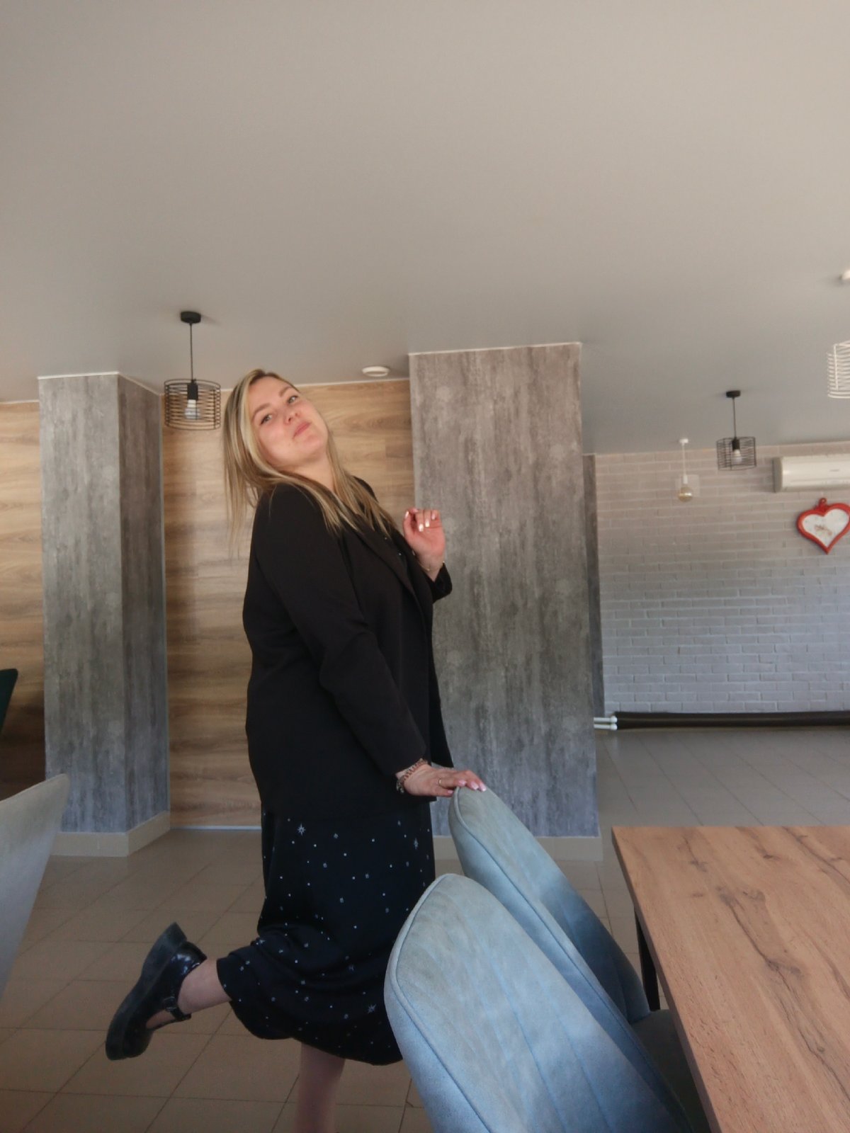 Woman poses indoors, cafe spotted in Noviy, Russia