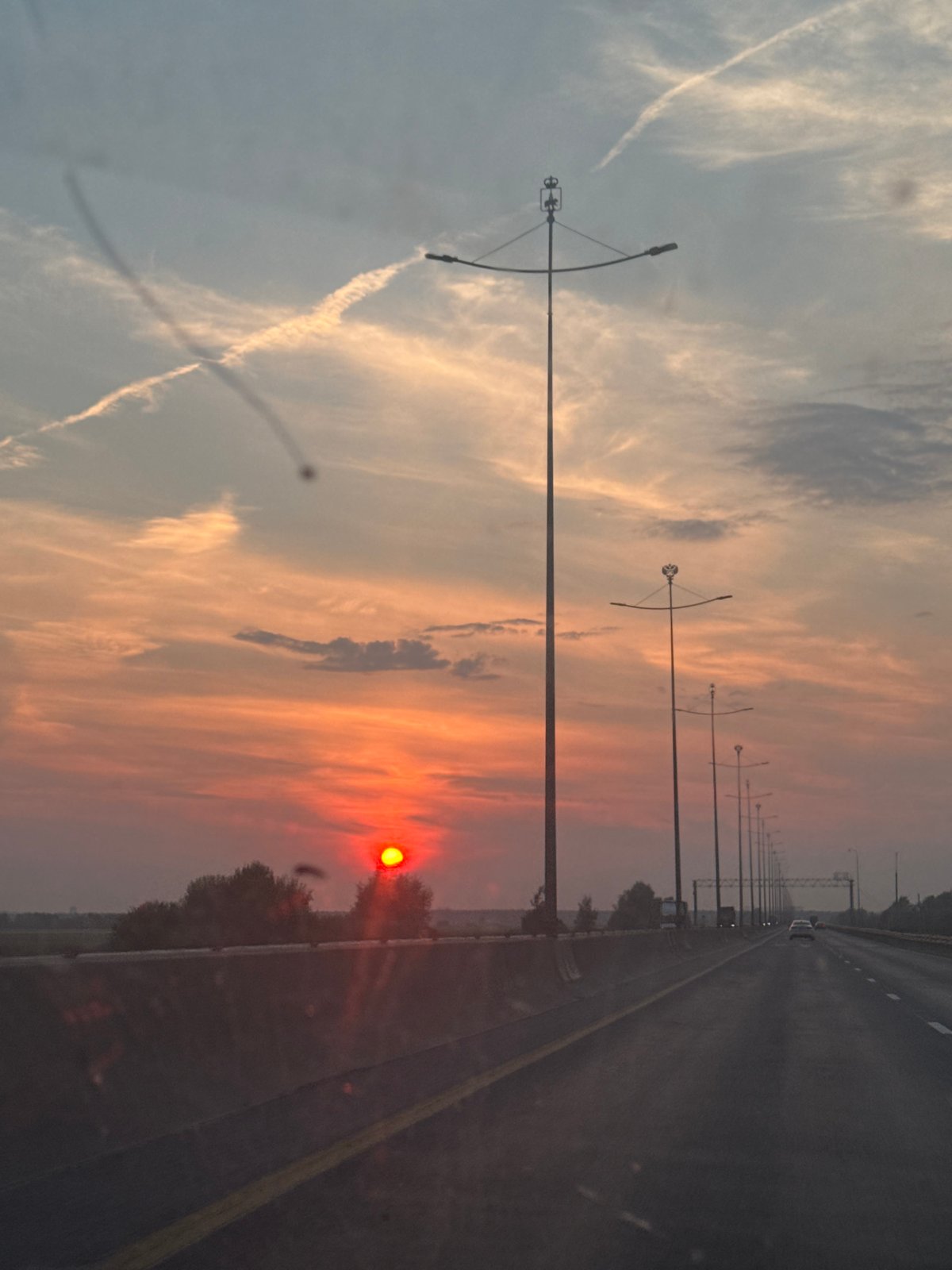 Red summer sunset over a Perm highway, July evening