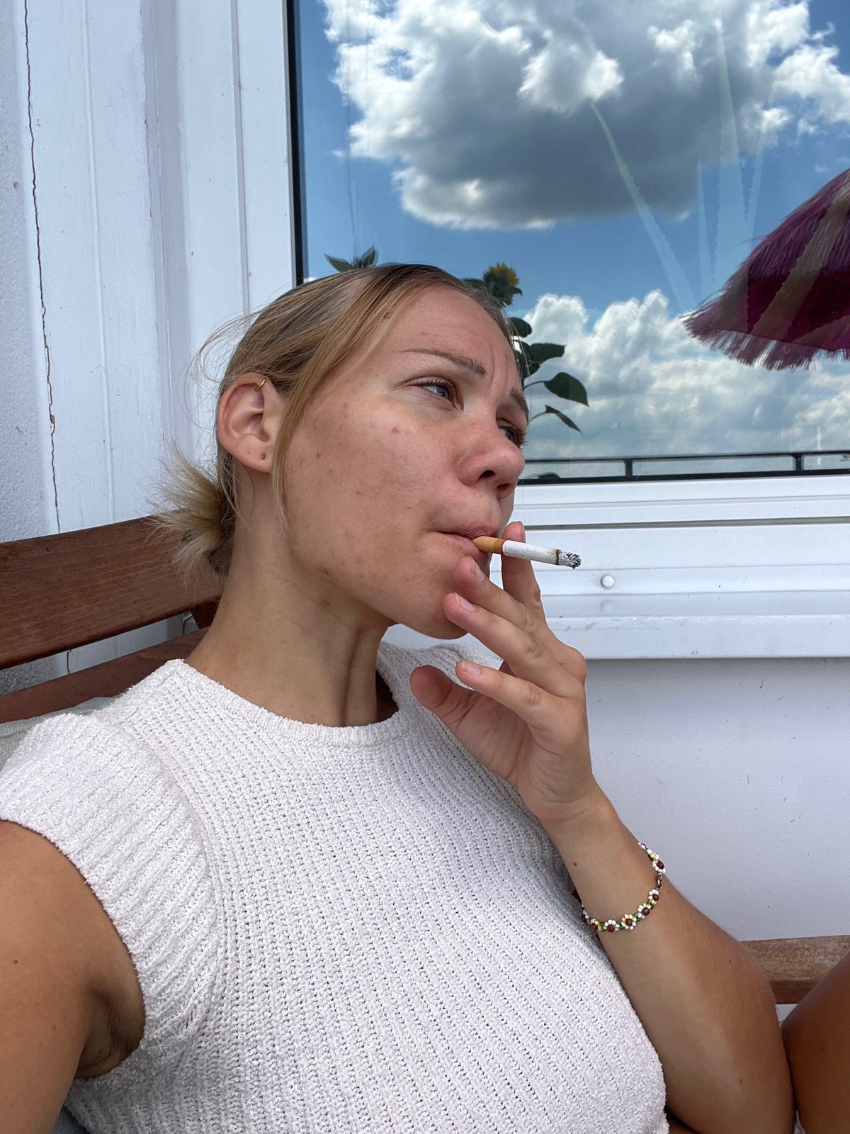 Balcony afternoon in Mühldorf — pink umbrella, cigarette, summer sun