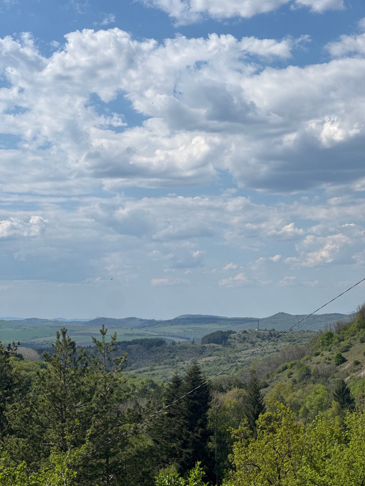 Observer documents cloud formations over Bulgarian countryside landscape