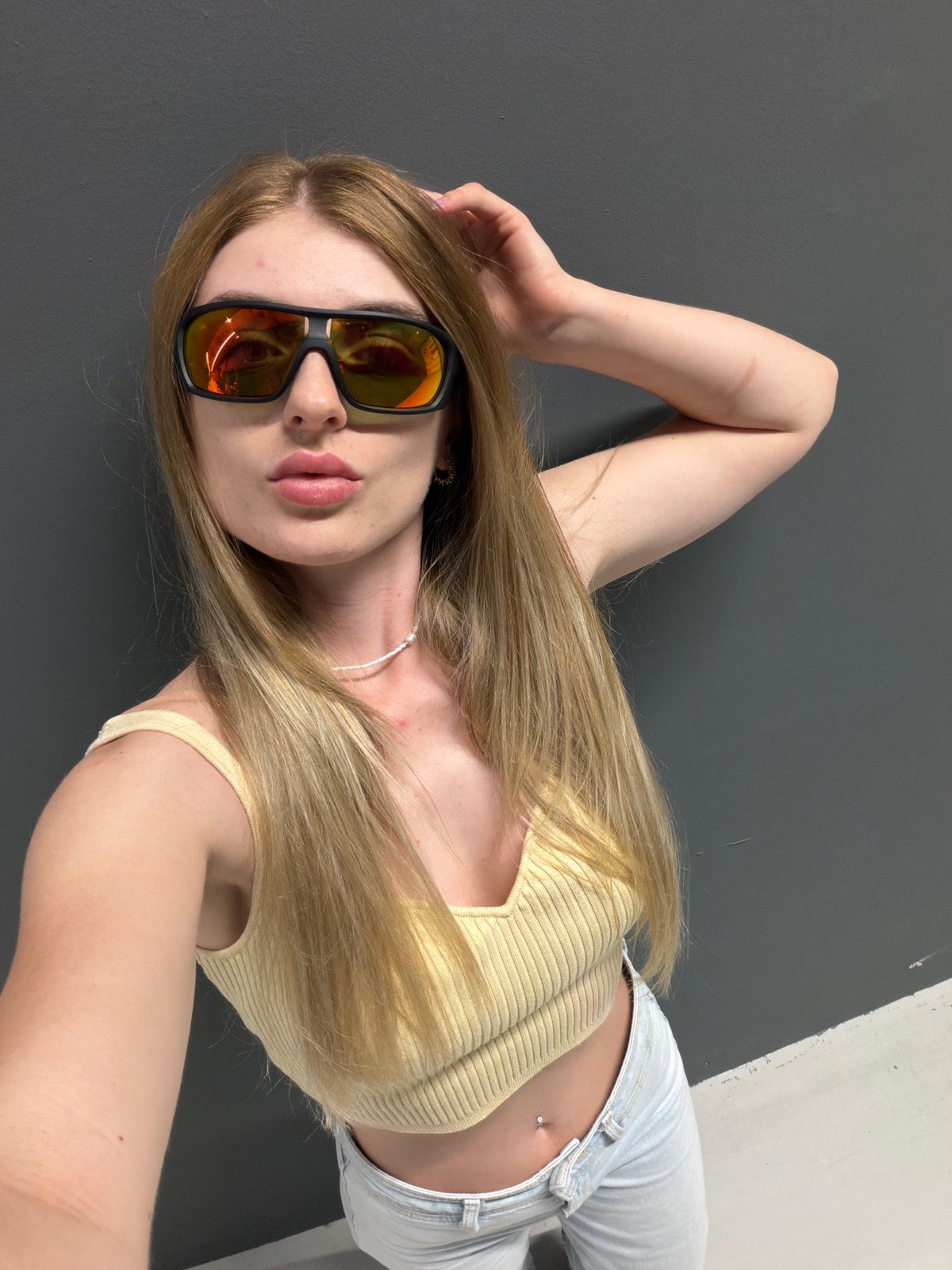 Selfie session in a gray-walled retail corridor