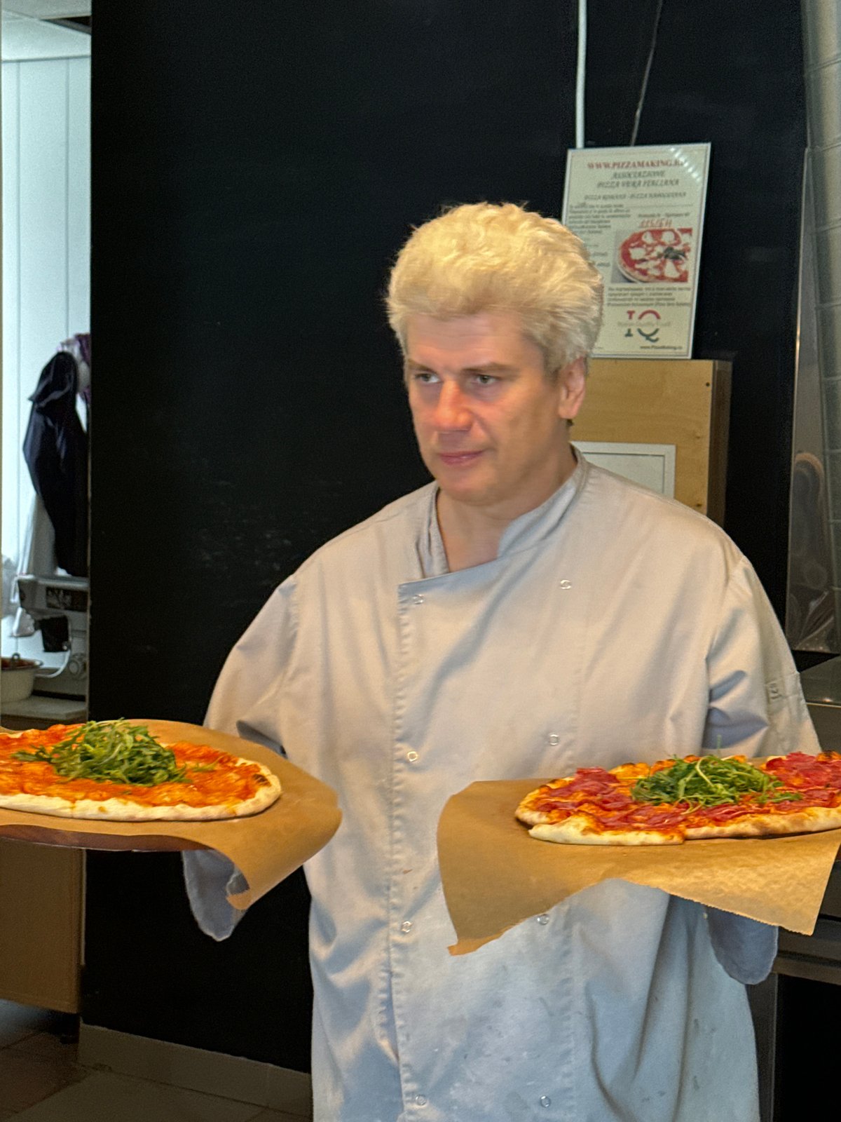 Chef prepares multiple pizzas at Saint Petersburg restaurant