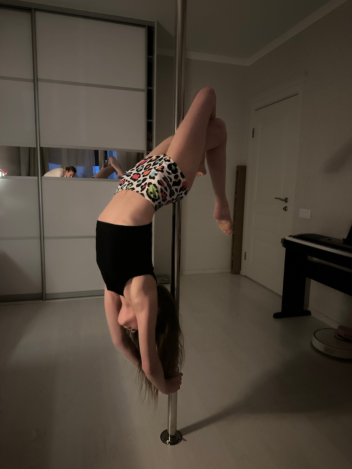 Woman performs pole dancing routine in Tomilino home