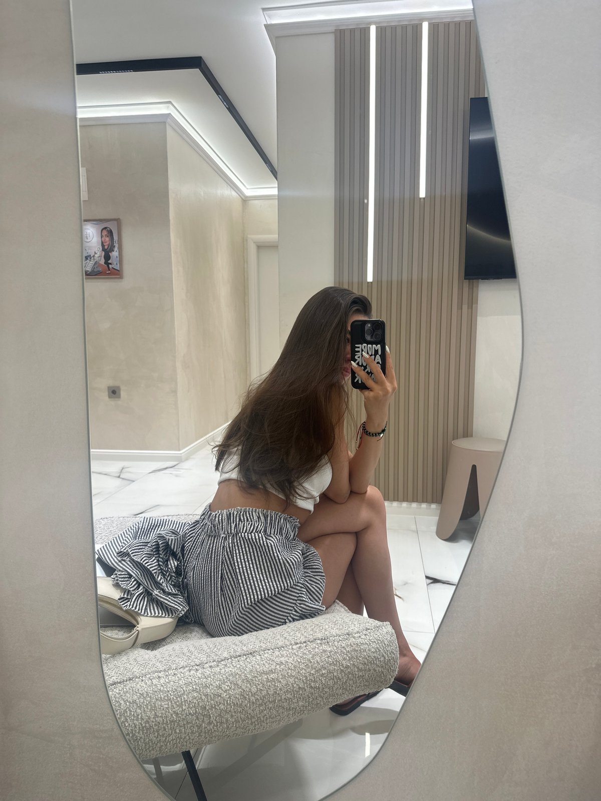 Mirror selfies inside a Petrich beauty salon or treatment room.