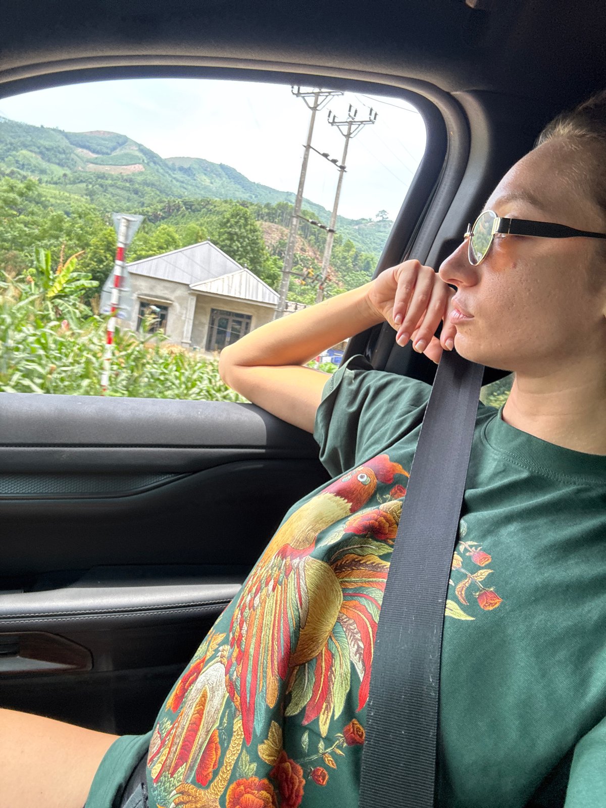 Passenger enjoys scenic mountain drive through rural Vietnam