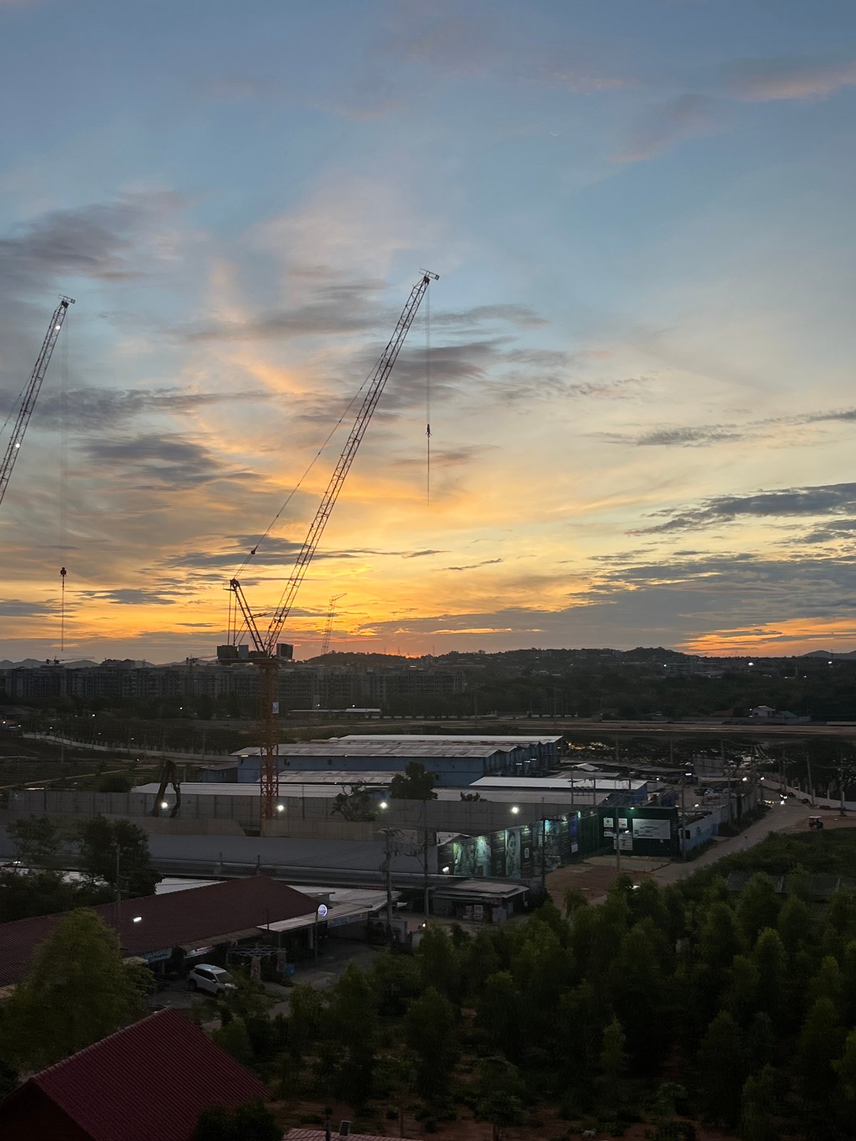 Construction cranes spotted during twilight in Pattaya City