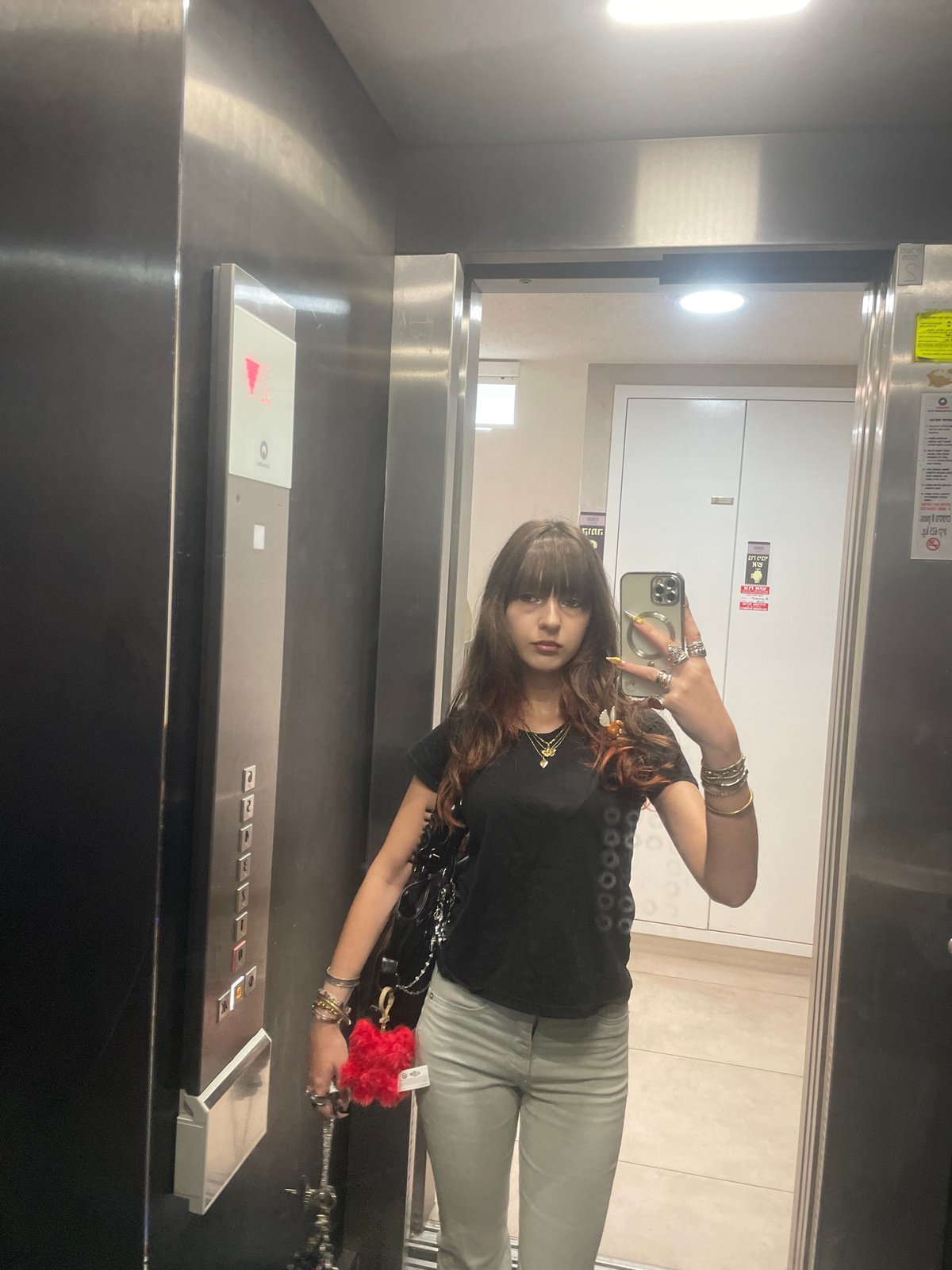 Woman takes morning selfies in Raanana elevator and outdoors