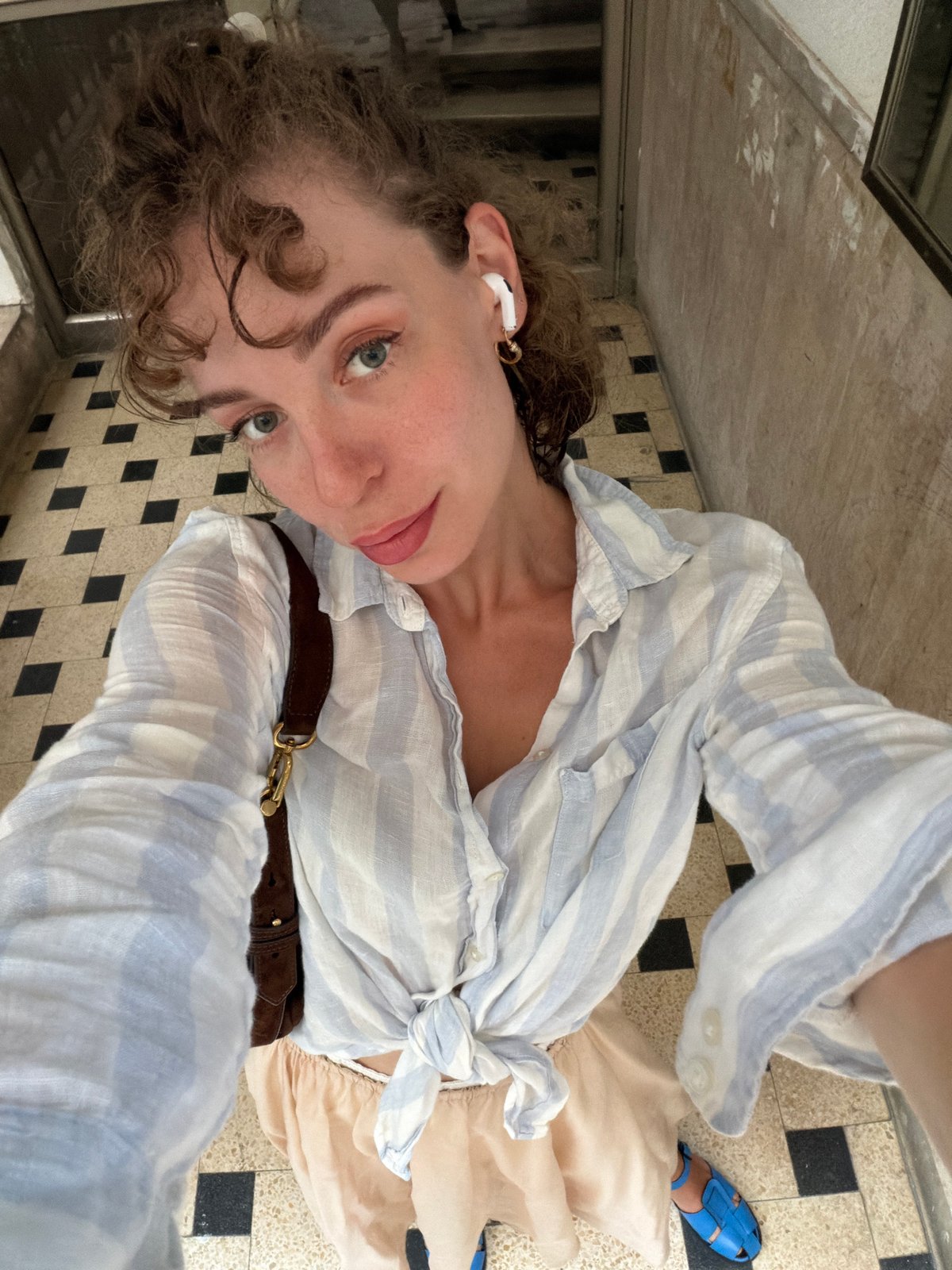 High-angle selfie on a checkerboard floor in Tel Aviv