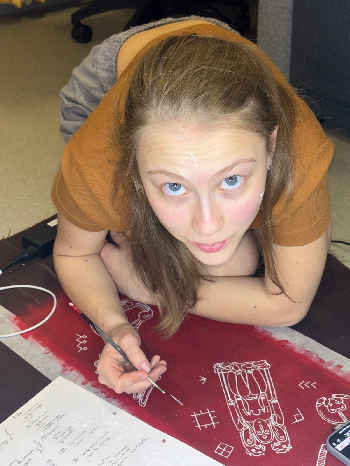 Artist paints traditional designs on fabric in Perm