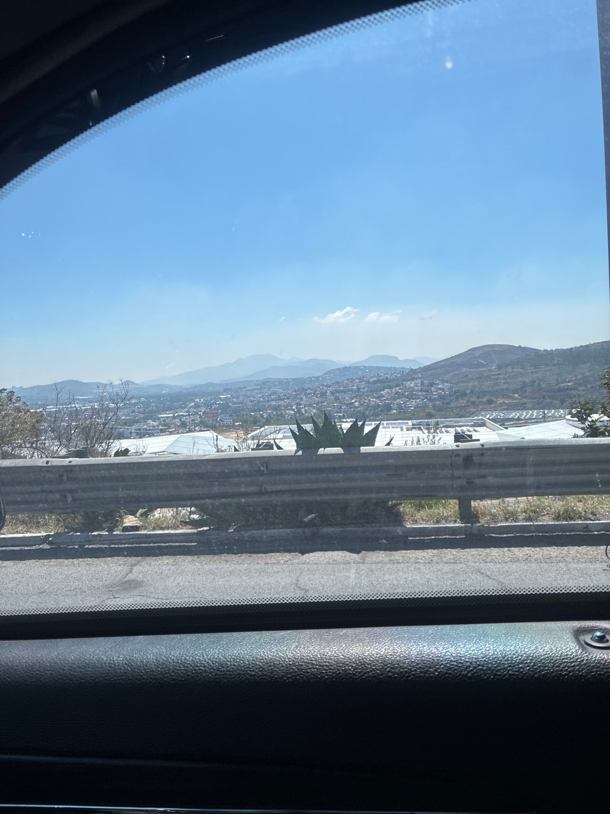 Vehicle travels highway in Ciudad López Mateos under clear skies