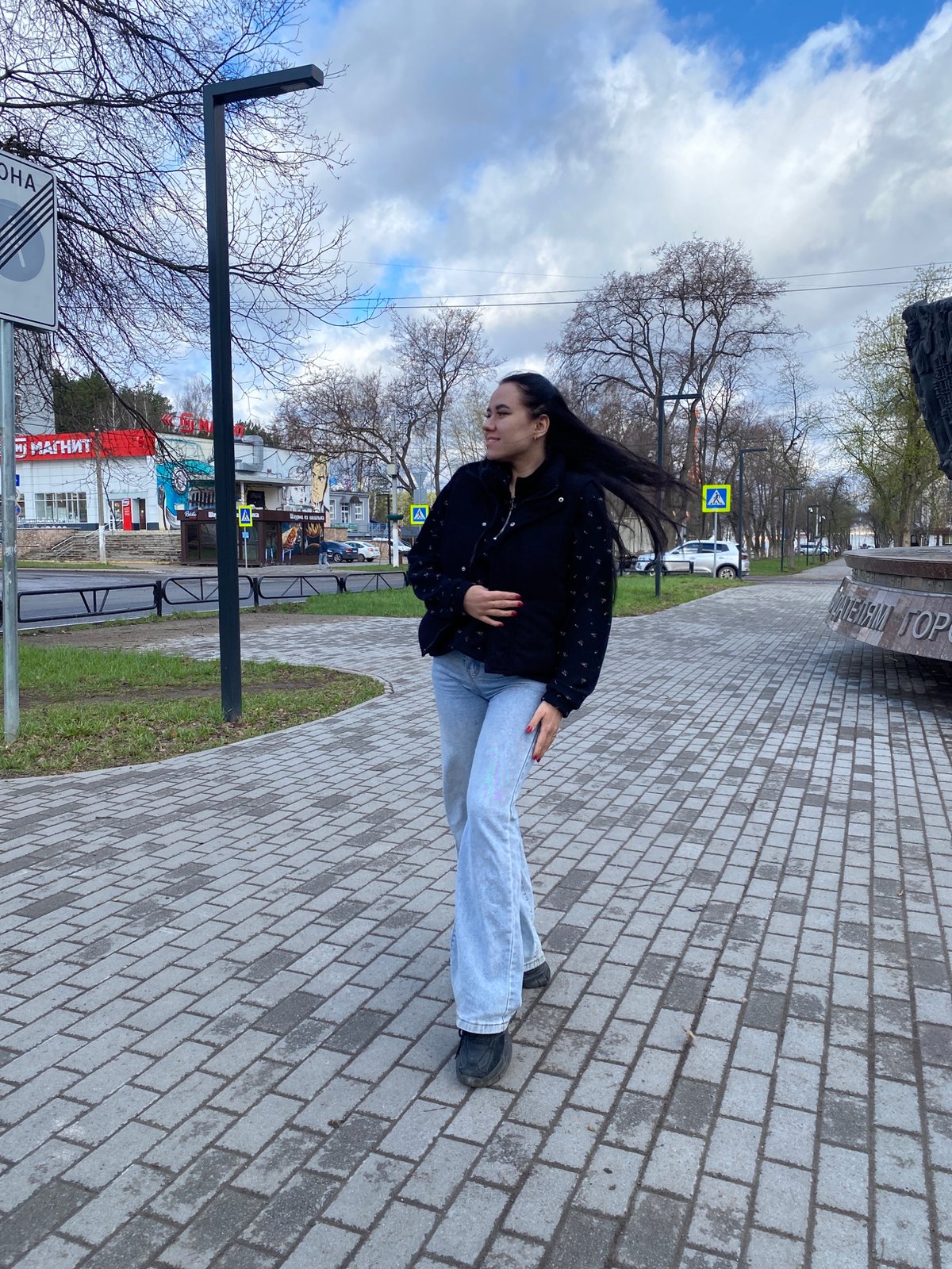 Young women photograph monument visit in Chaikovsky, Russia