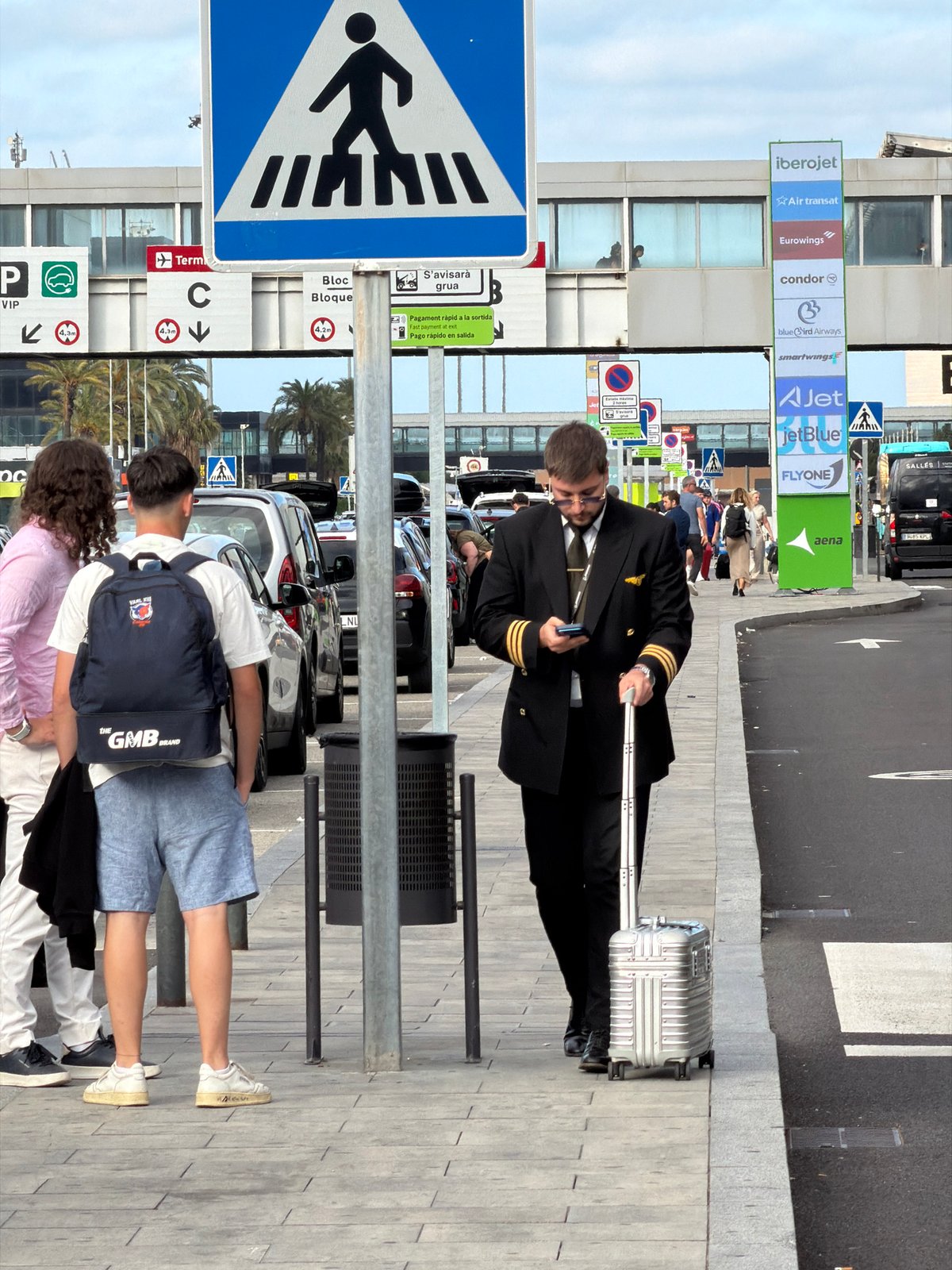 Family travels through Barcelona airport during evening hours