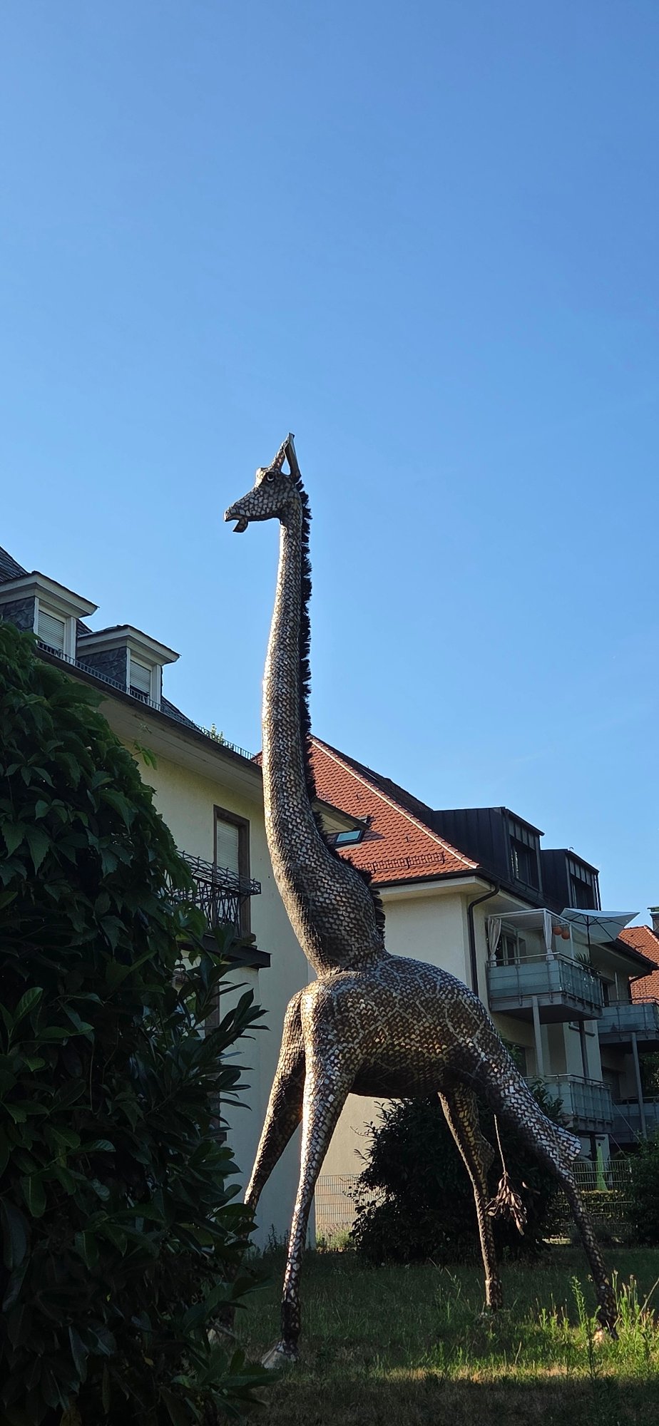 Metallic giraffe sculpture and canal at Karlsruhe Zoo
