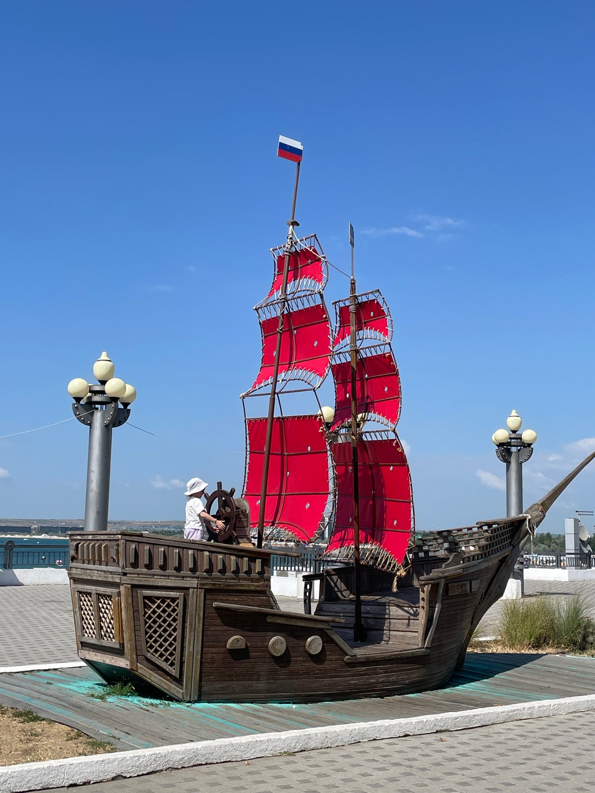 Sunny day at Anapa's waterfront: pirate ship, art, and wakeboarding
