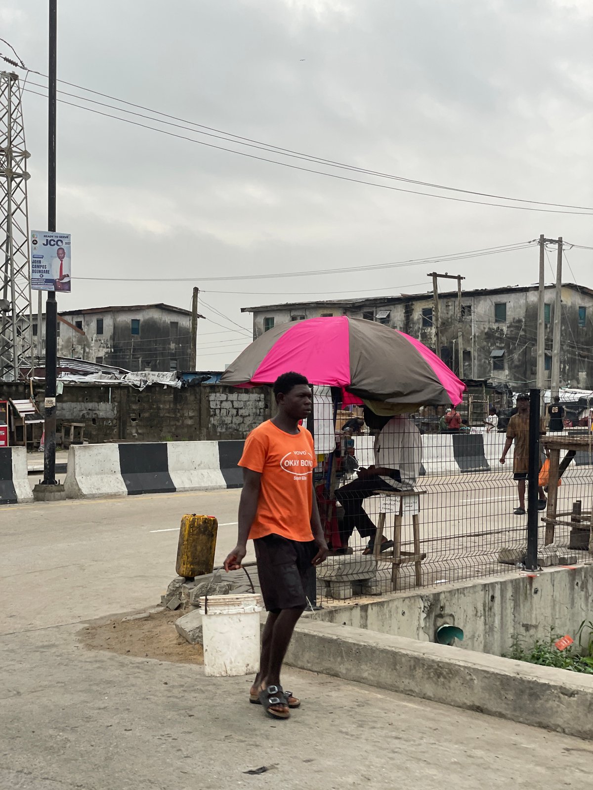 Street activity and church signage on a cloudy Igboefon morning