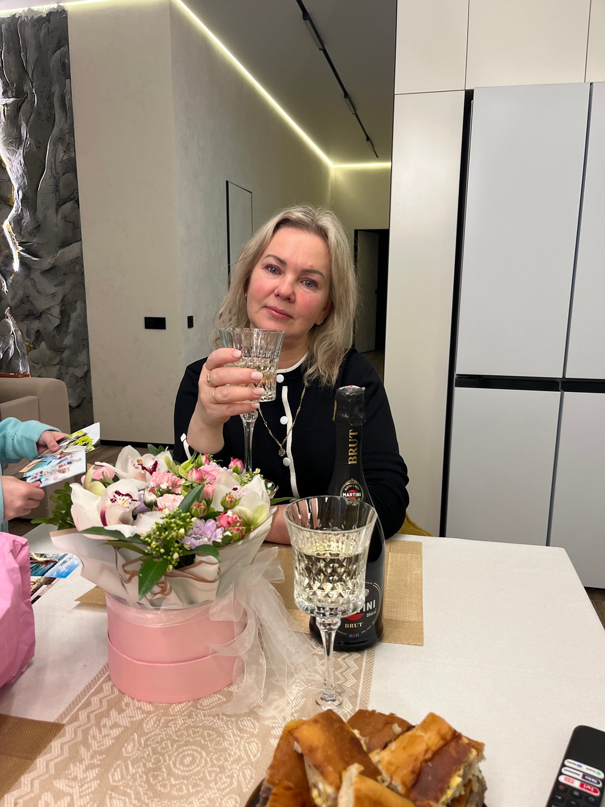 Woman receives flower bouquets in intimate home moment