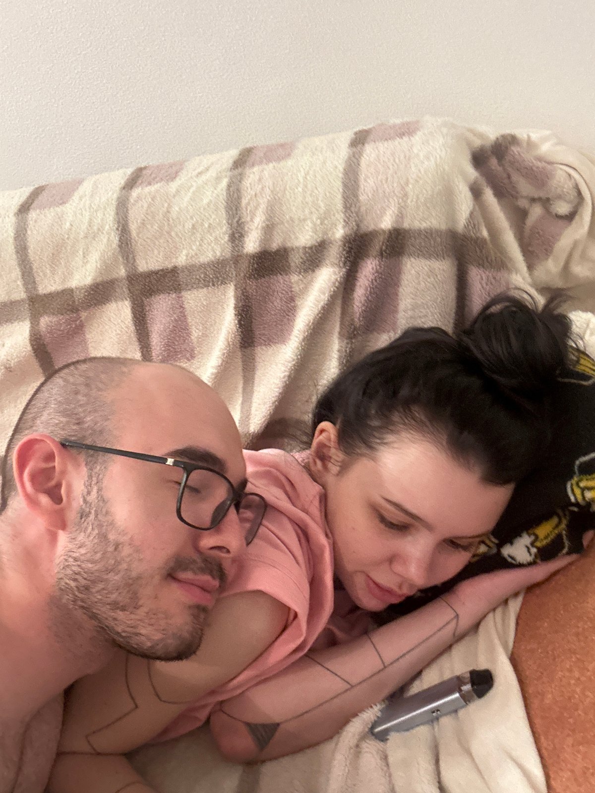 Couple photographed resting together in Lyubertsy bedroom