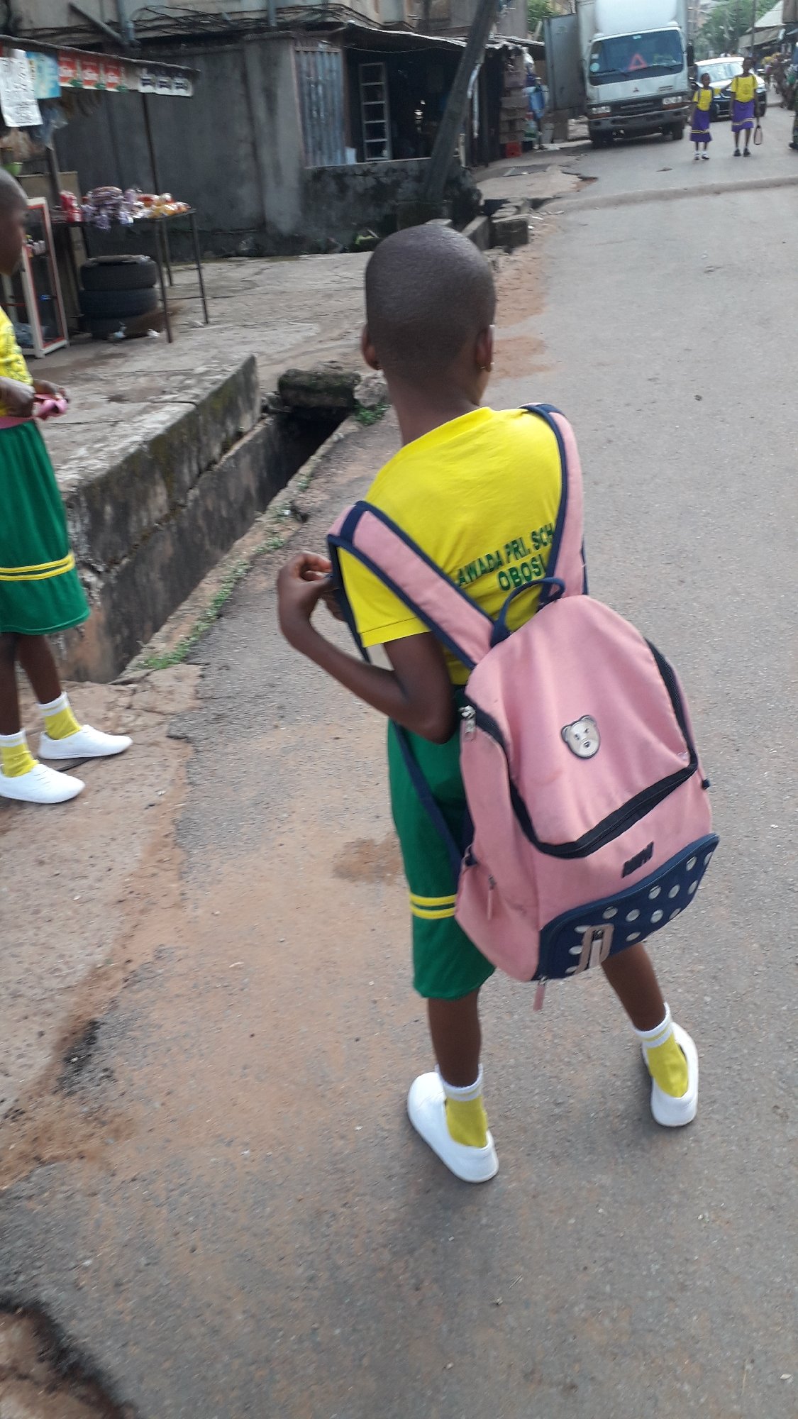School children commute through Onitsha streets during morning hours