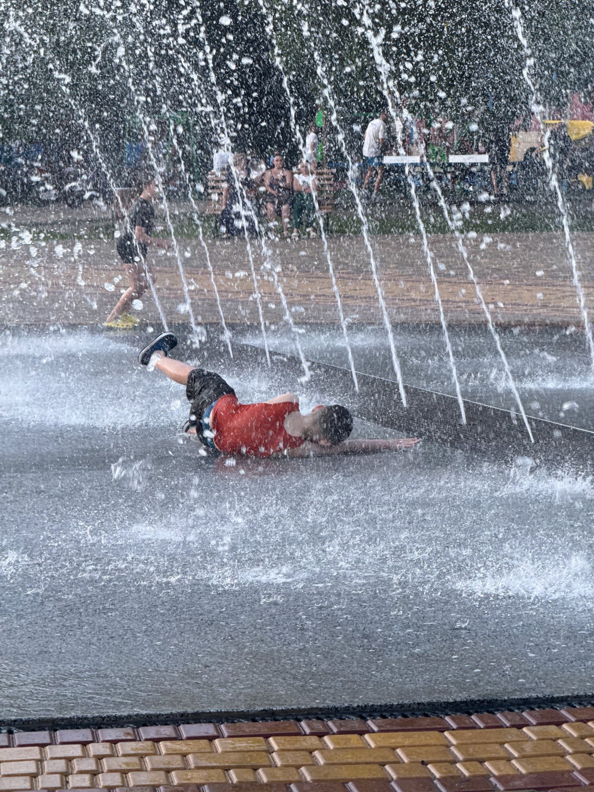 Summer afternoon at a Ukrainian park fountain and plaza