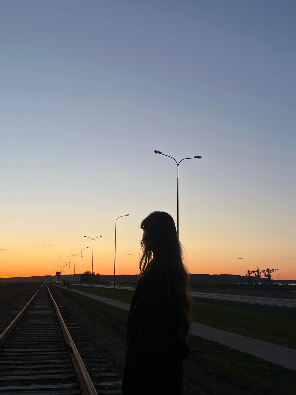 Sunset scenes captured near railway tracks and harbor in Chaikovsky