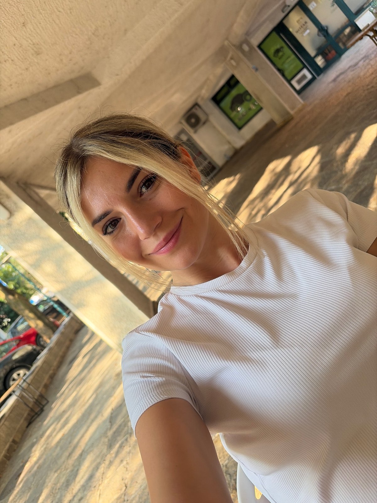 Morning coffee prep at a Budva cafe, with street life outside