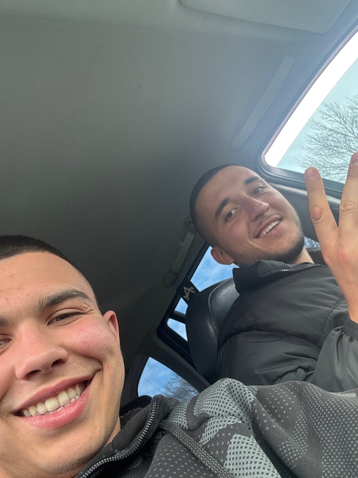 Two men pose for photo in car in Varna