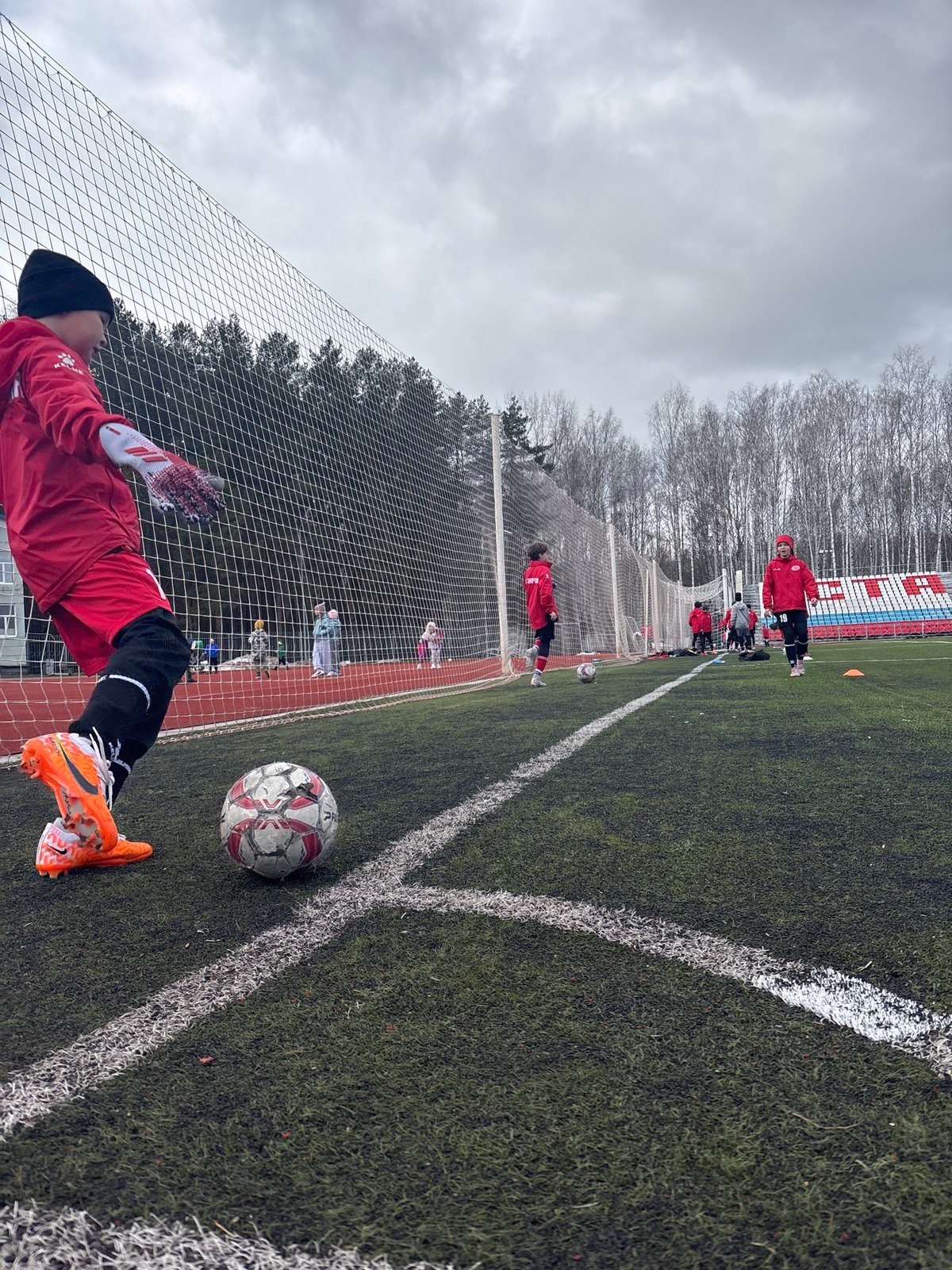 Early morning soccer practice session at Chaikovsky Central Stadium