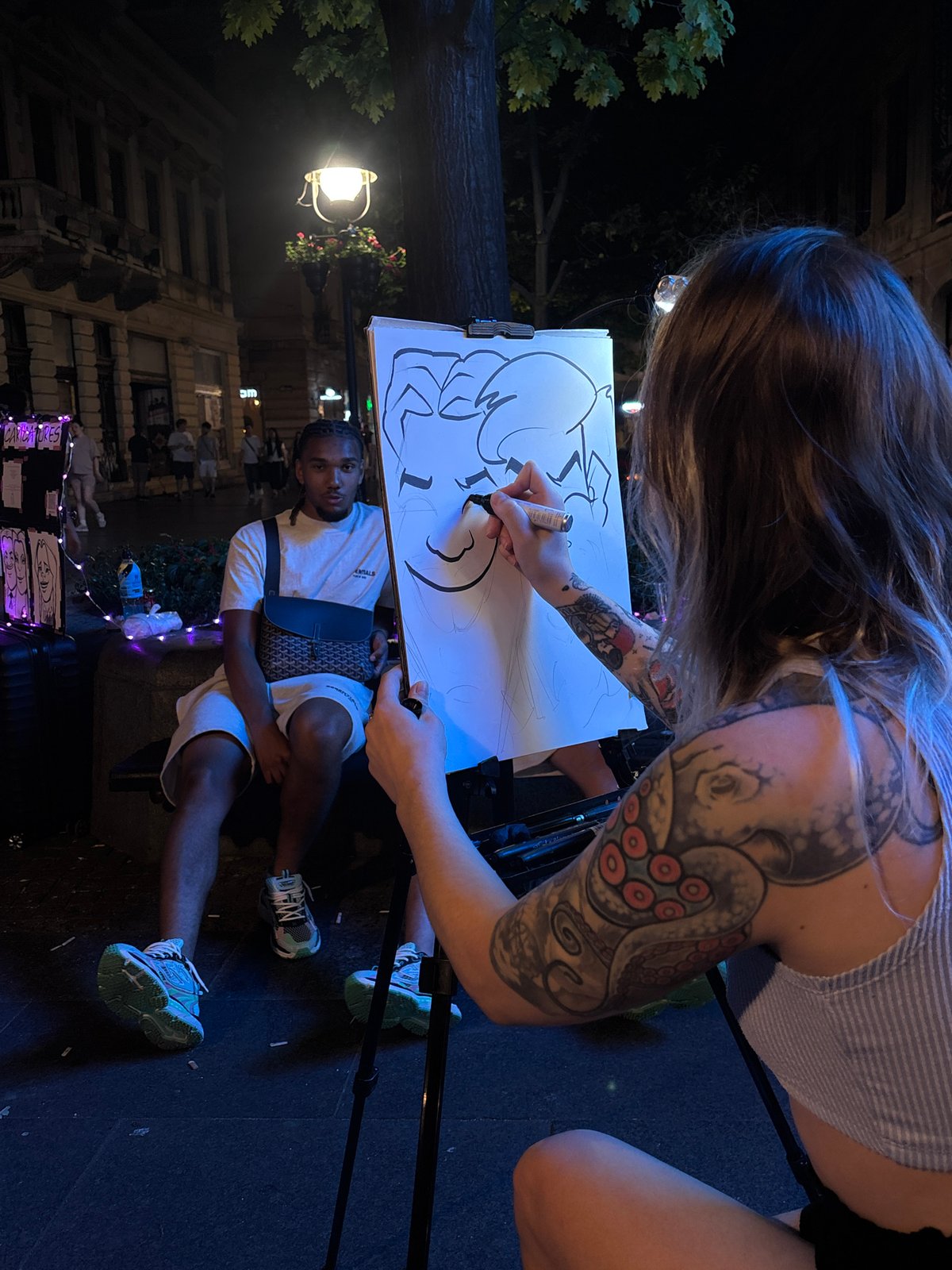 Street caricature artist at work in Belgrade at night
