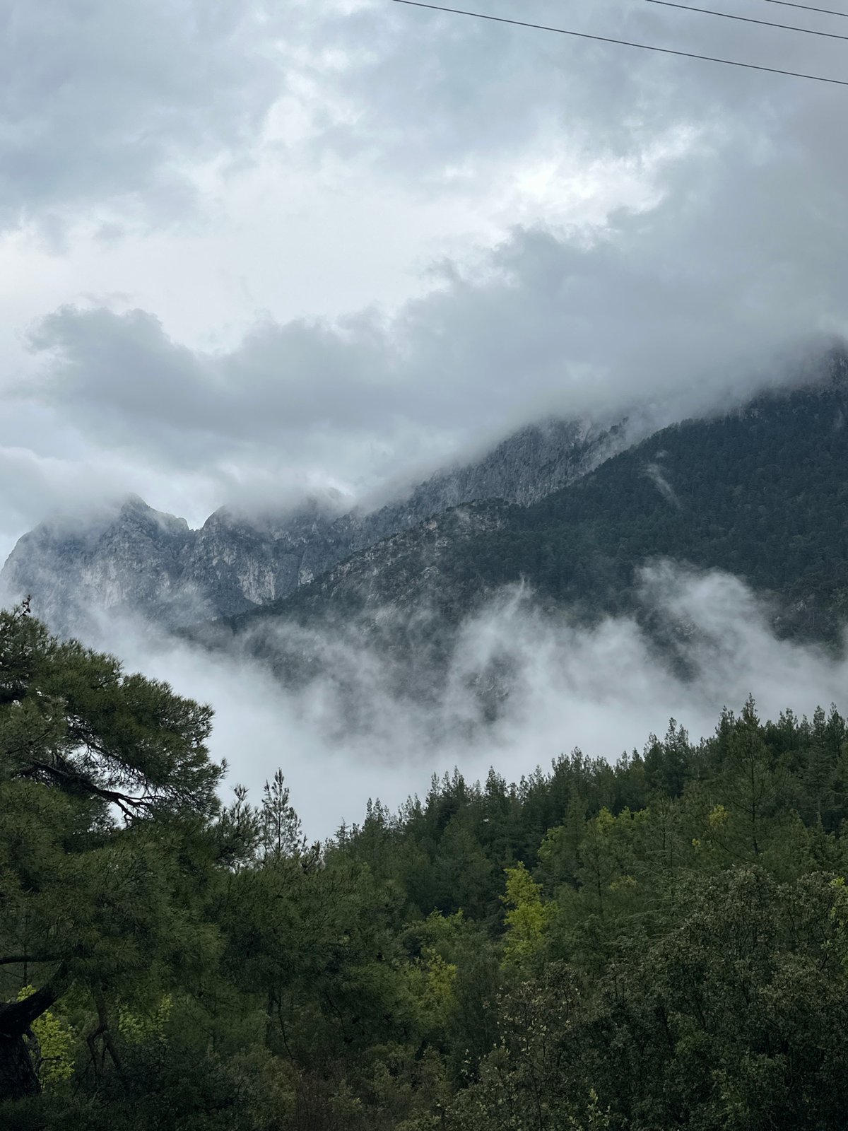 Fog envelops mountains near Konyaaltı residential area