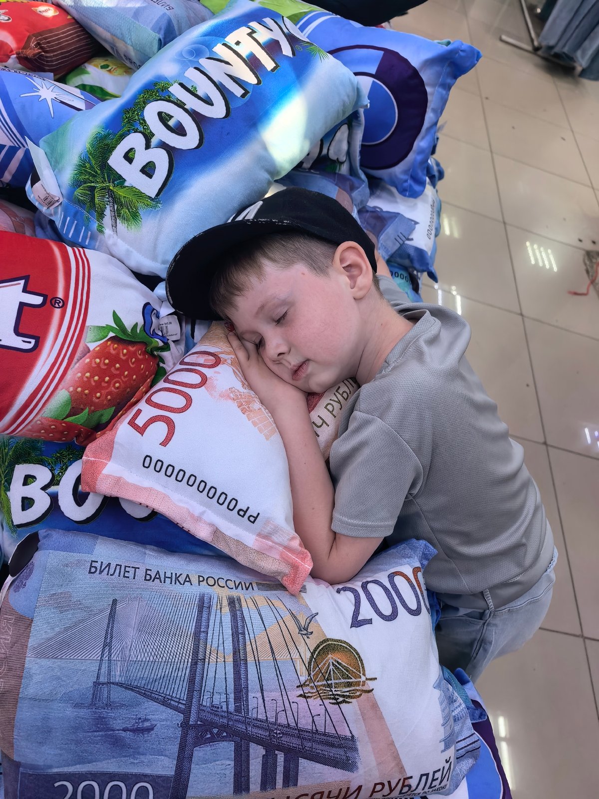 Child naps on novelty food-themed pillows in Russian store