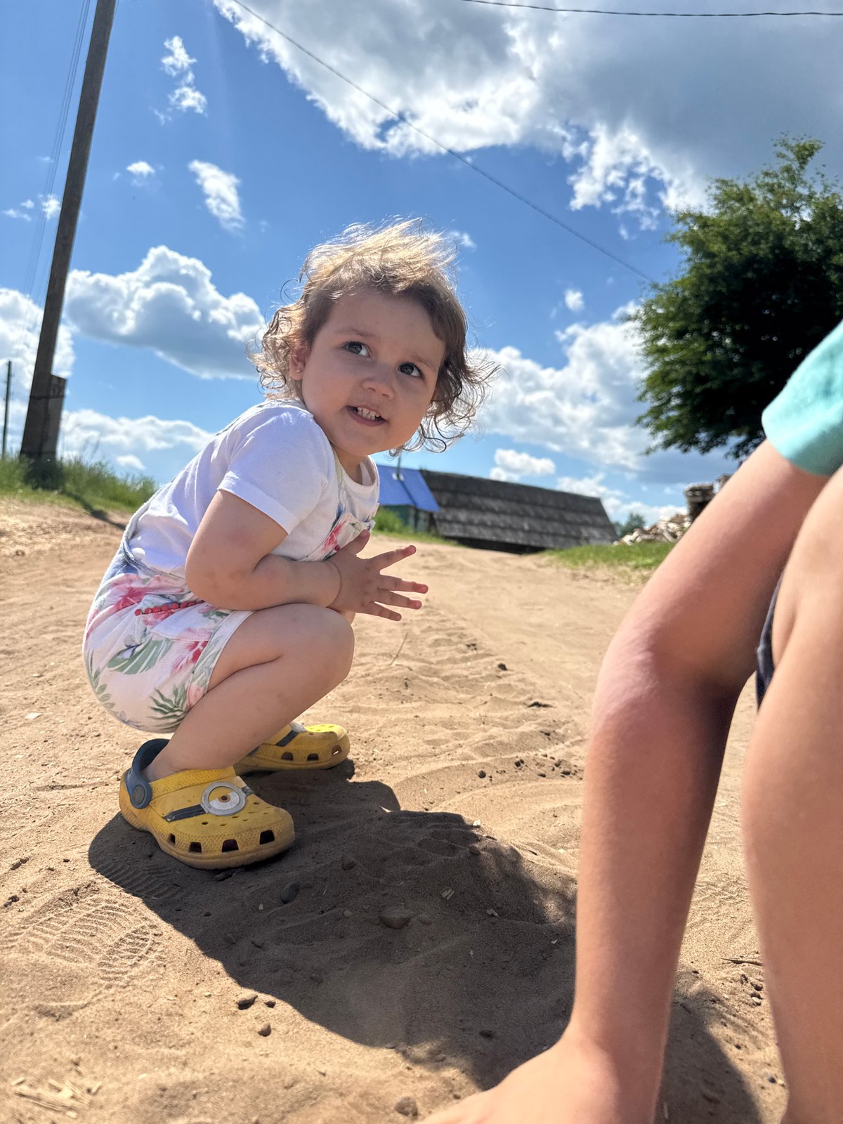 Child explores rural landscape during morning outing in Russia