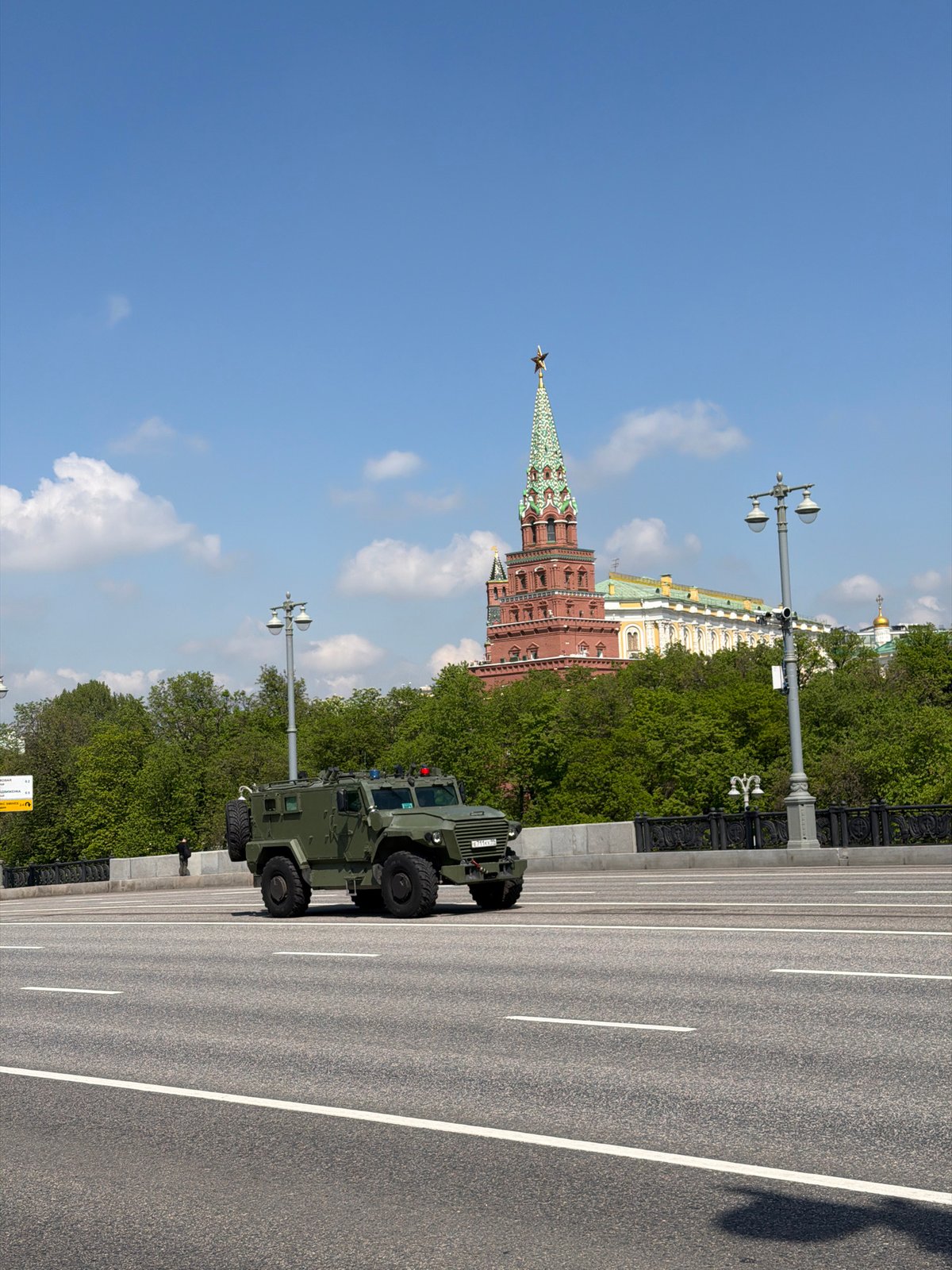 Military vehicles spotted on urban streets alongside civilian traffic