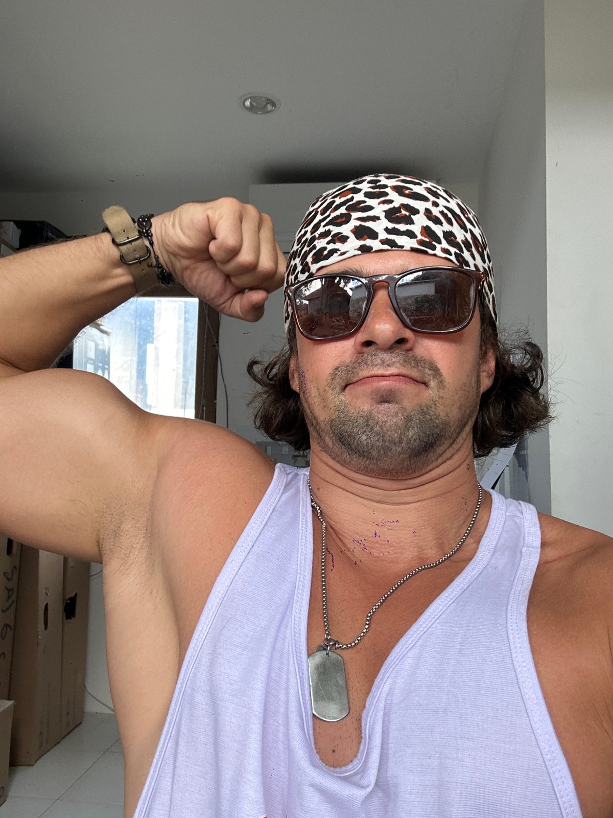 Flexing in leopard print bandana and light purple tank top