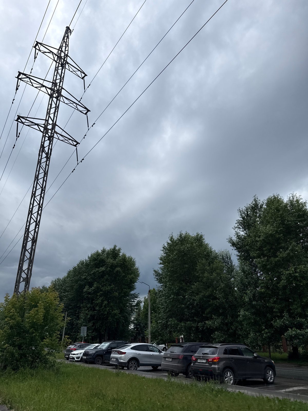 Power pylons and utility lines under a cloudy sky