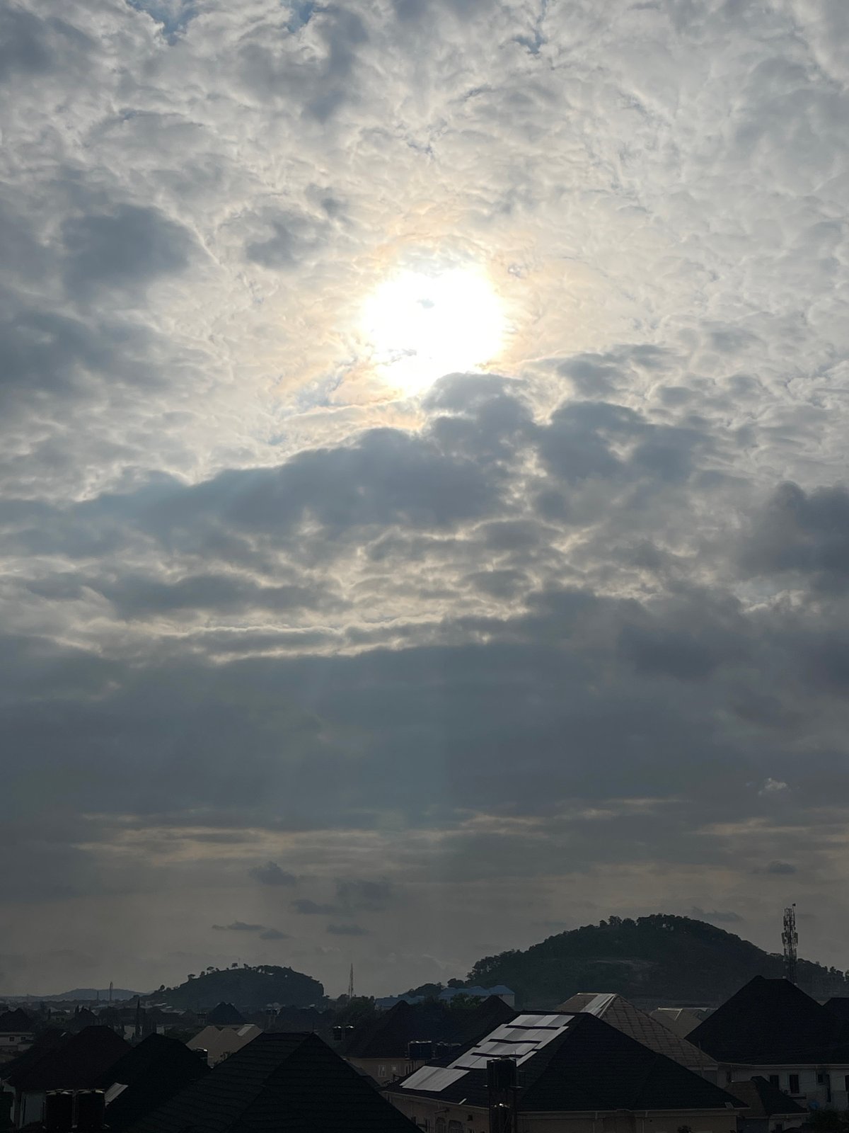 Abuja residential neighborhood under dramatic overcast skies