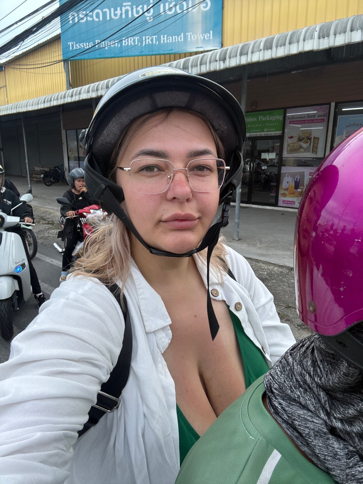 Riding through Karon's streets past shops and hillside housing