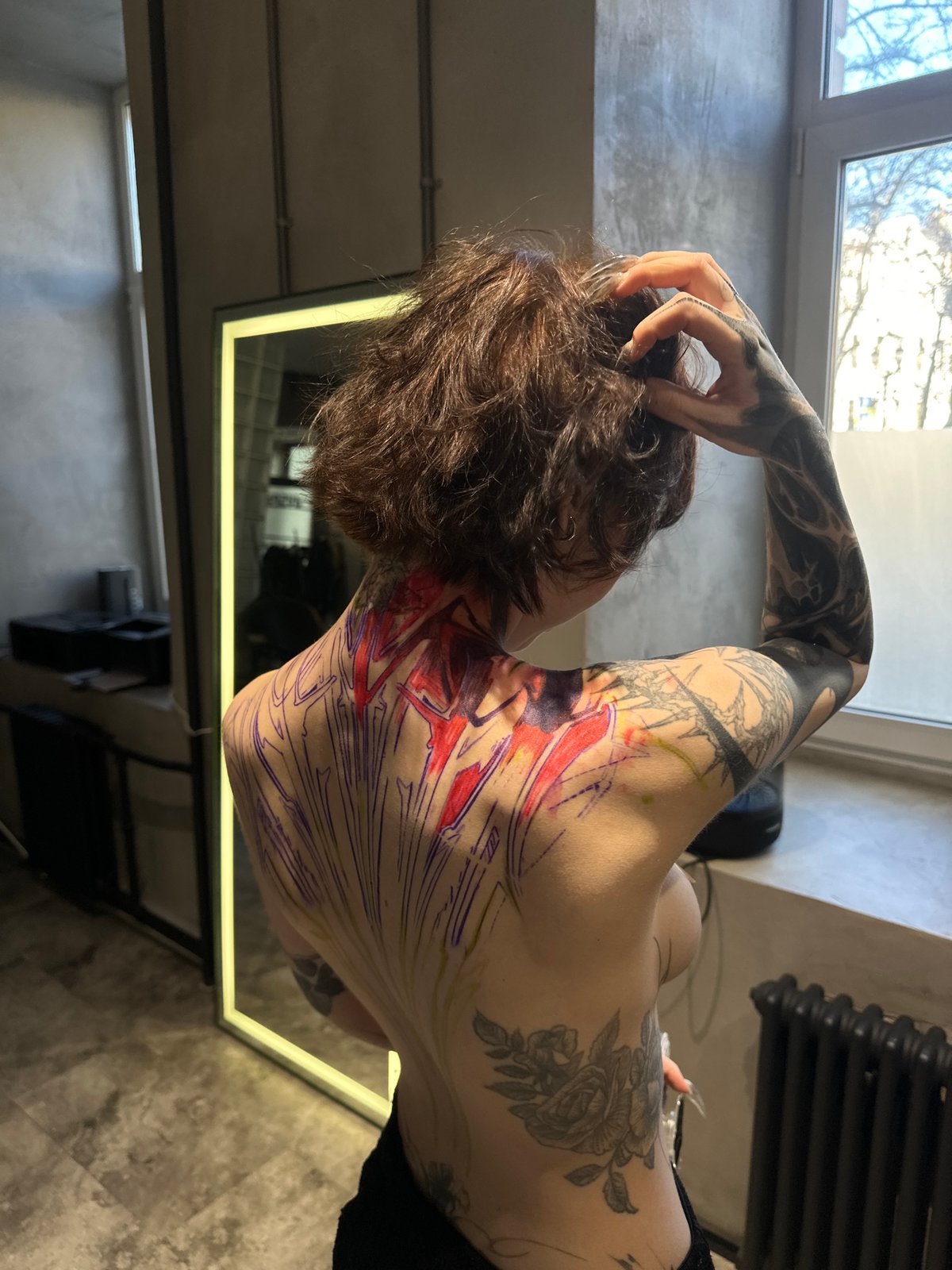 Tattoo session documented through selfies at Moscow parlor