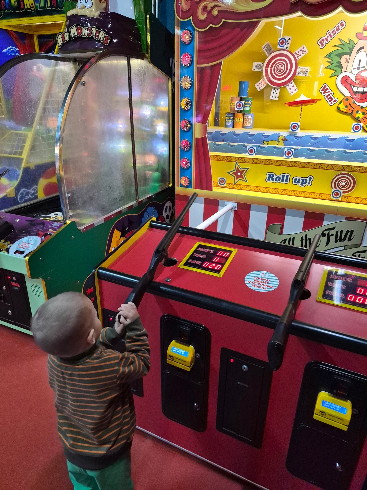Child plays arcade games at entertainment center in Tobolsk
