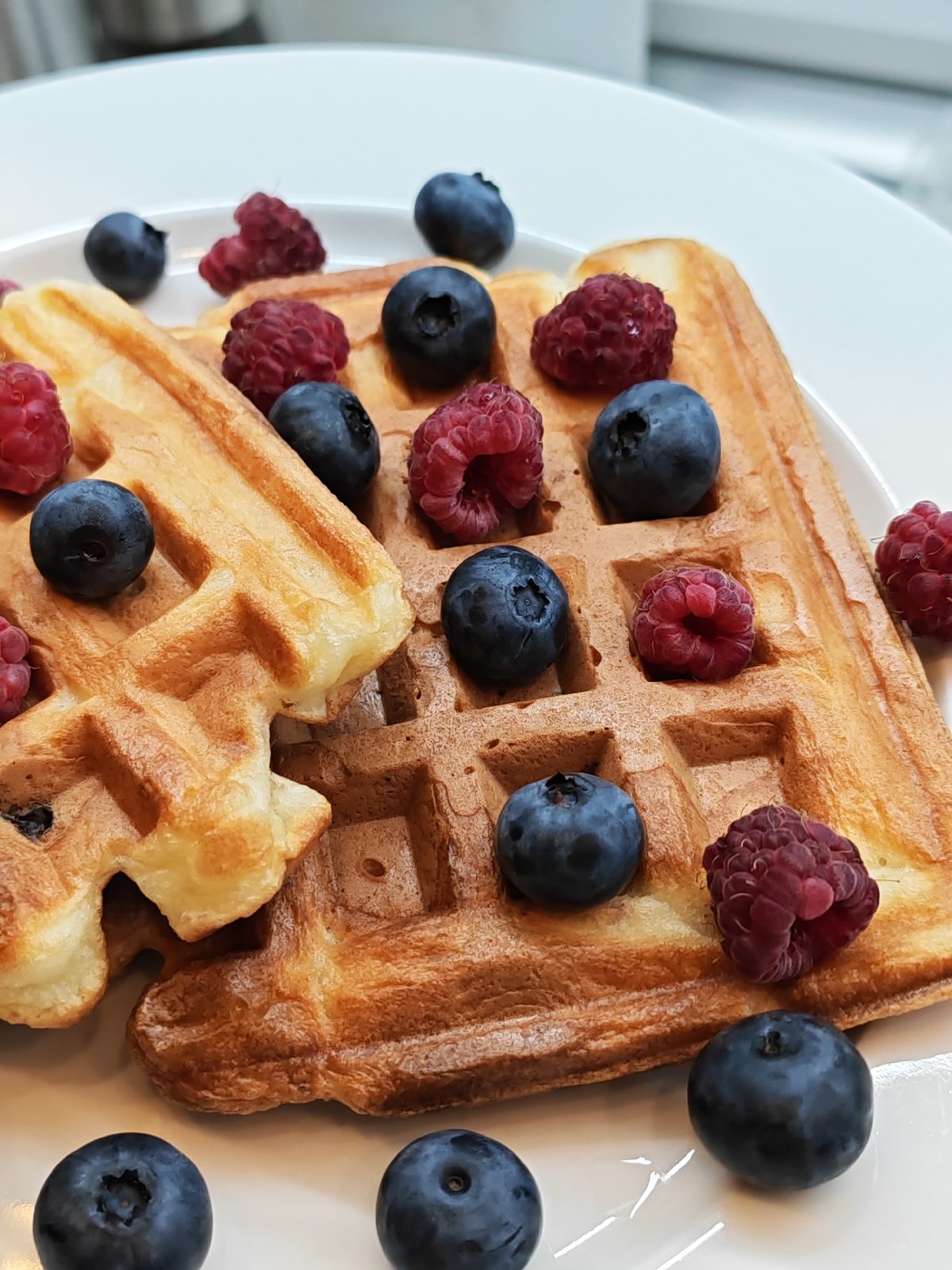 Waffles with fresh berries on a kitchen counter in Bataysk