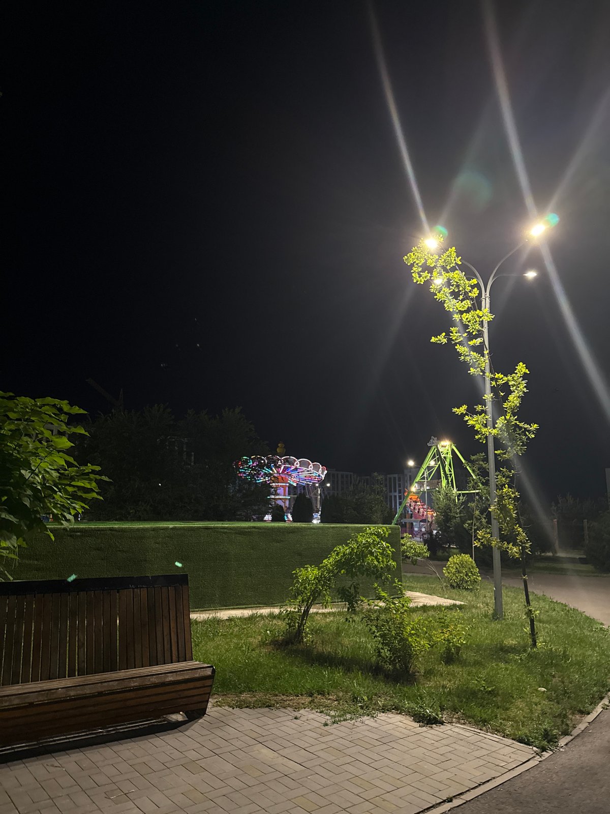 Almaty amusement park alive at night with rides and lights