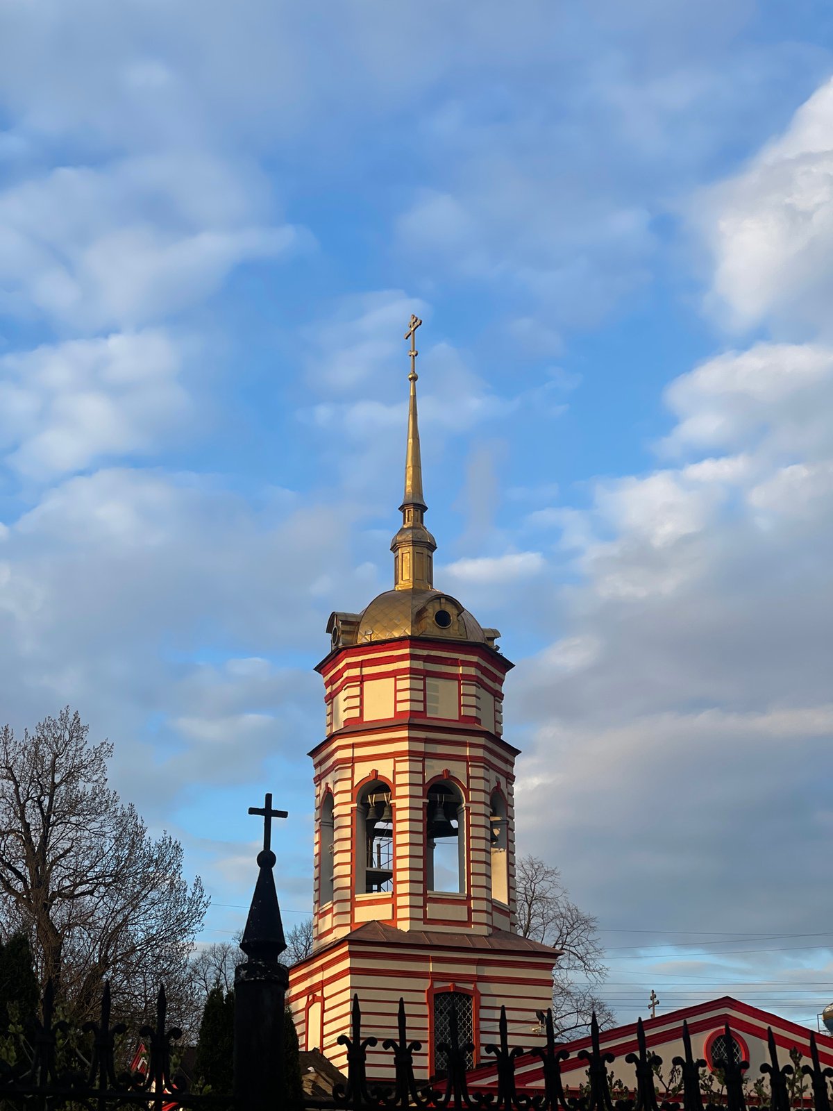 Striped church tower documented in Moscow under blue skies