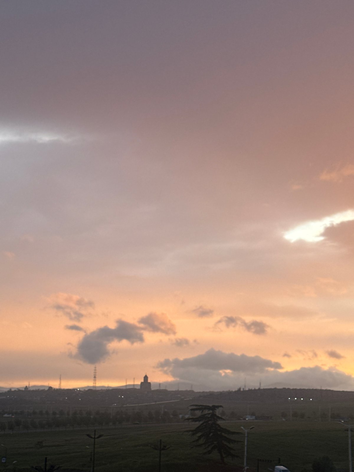 Colorful sky gradient observed over Tbilisi cityscape